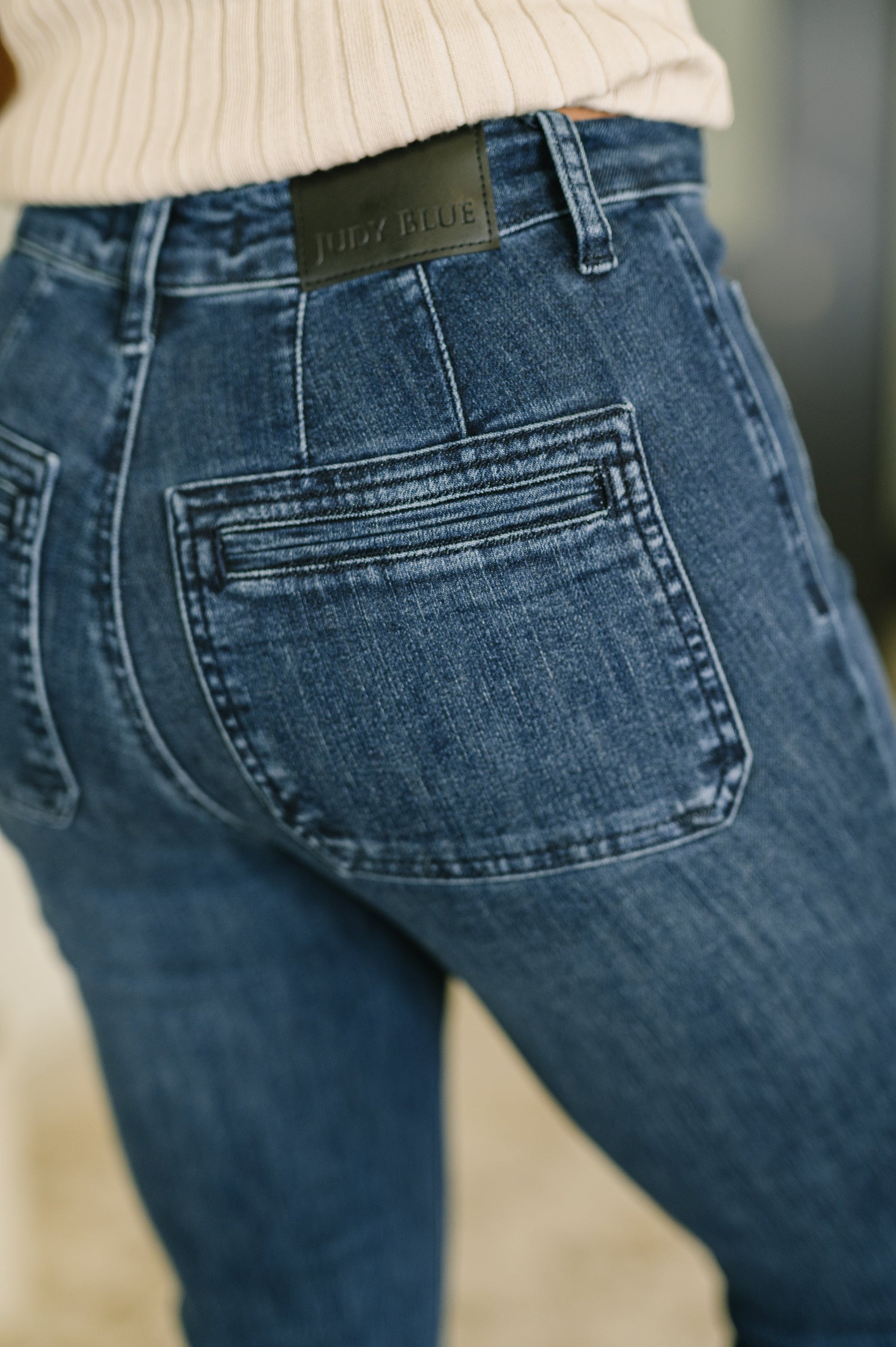 Pocket close-up of Mackenzie High Waist Flare Jeans showing stretch denim texture.