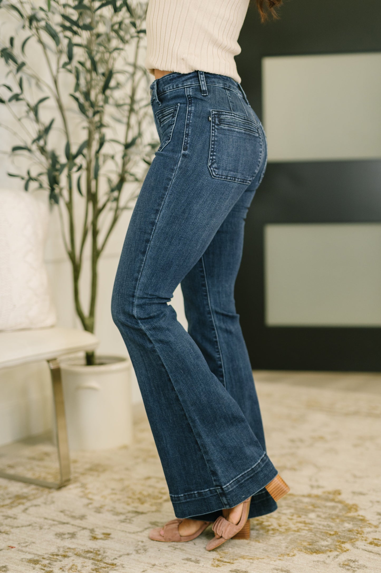 Side angle of Mackenzie Flare Jeans highlighting exaggerated hem and flare leg.