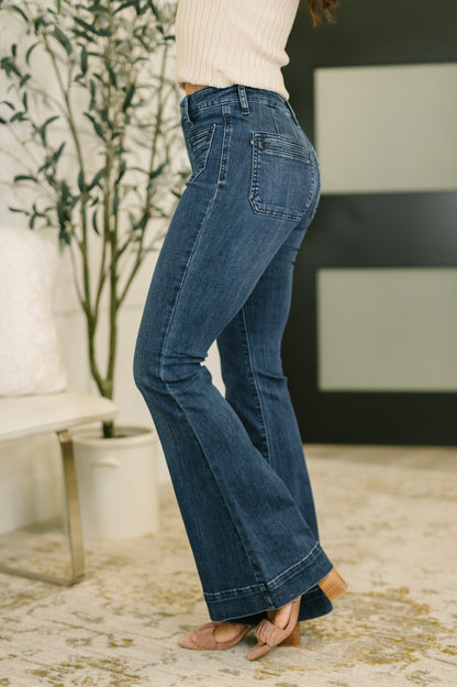 Side angle of Mackenzie Flare Jeans highlighting exaggerated hem and flare leg.