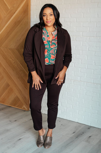 Plus size woman wearing open front chocolate blazer with ruched sleeves, stylish and versatile.