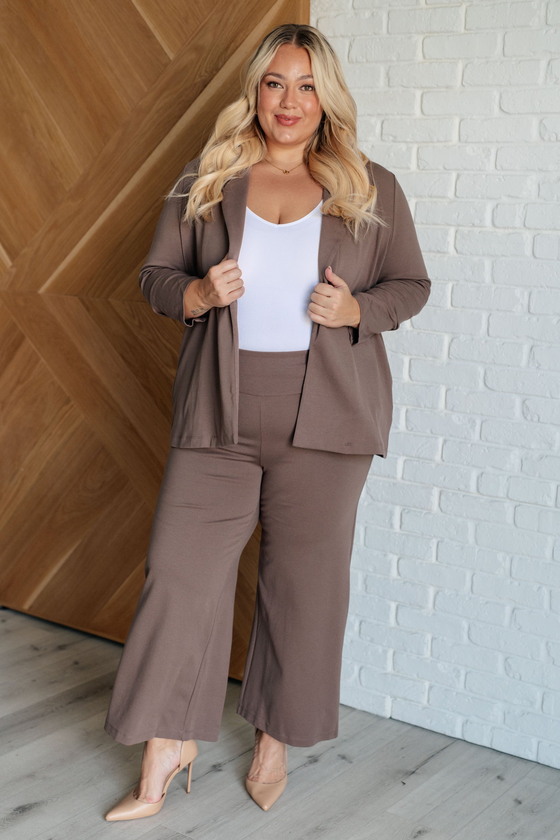 Wide Leg Crop Pants in dark mocha, made from high-stretch ponte knit fabric. Cropped, wide-leg design with faux welt pocket. Perfect for effortless style.