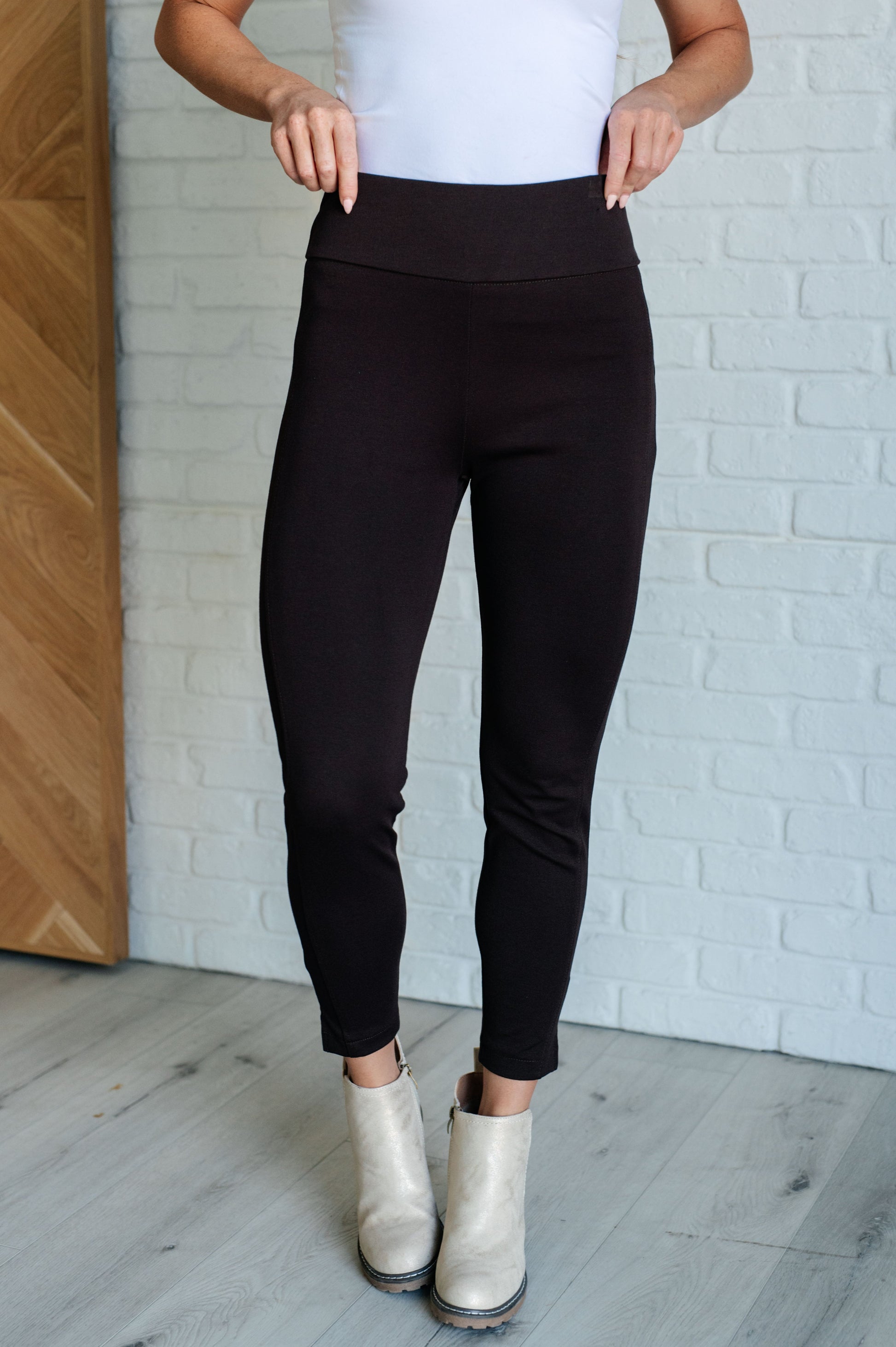 Skinny Pants in Chocolate, high-rise, slim-fit ponte knit fabric with tuxedo stripe, faux welt pockets, and ankle crop. Features elastic waistband and cuff slit.