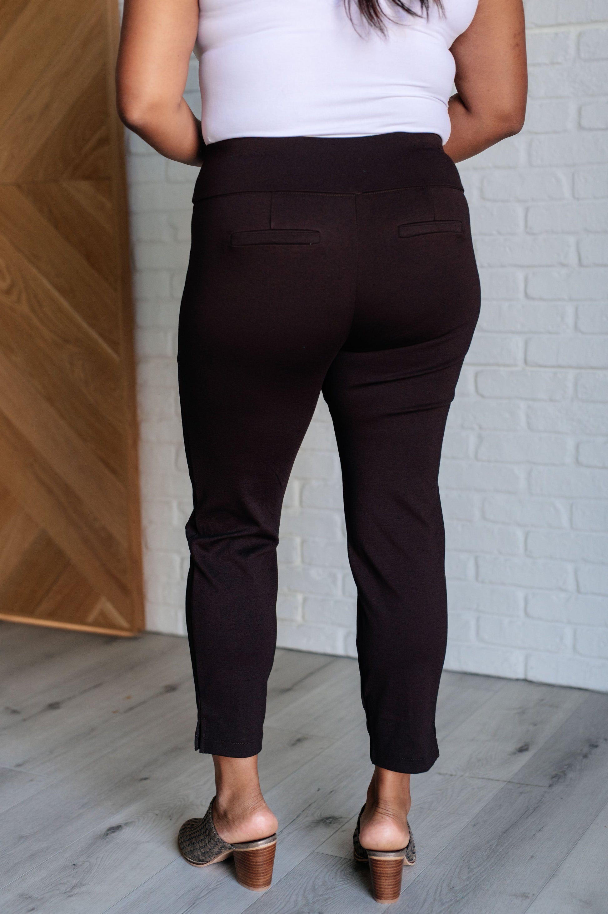 Skinny Pants in Chocolate, high-rise, slim-fit ponte knit fabric with tuxedo stripe, faux welt pockets, and ankle crop. Features elastic waistband and cuff slit.