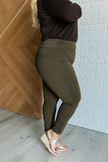 Plus size side view of Midge Magic Skinny Pants in olive highlighting flattering high-rise waist and slim silhouette.