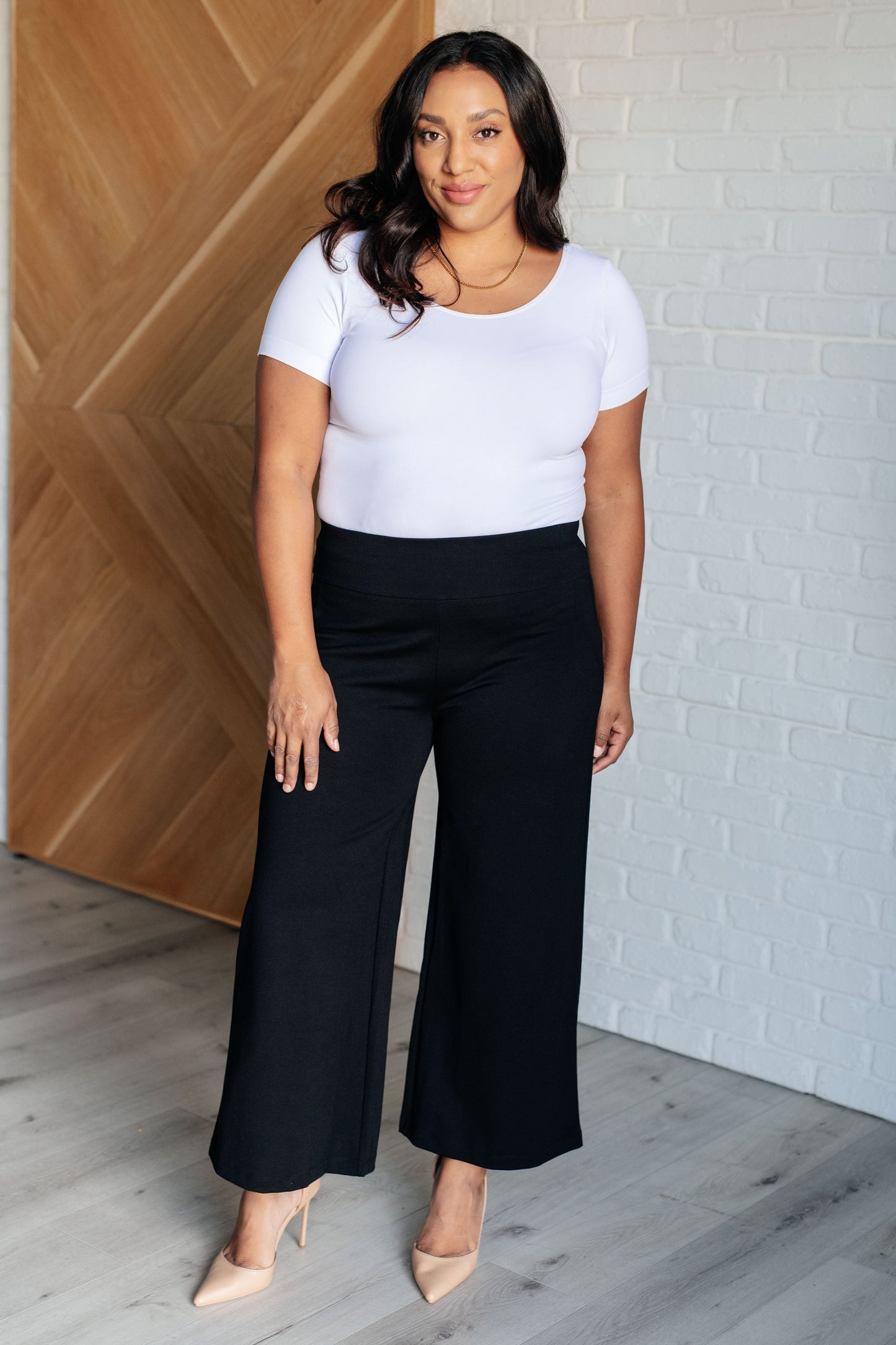 Wide Leg Crop Pants in Black, made of stretchy ponte knit with faux welt pockets, high stretch, and a chic cropped wide-leg design.