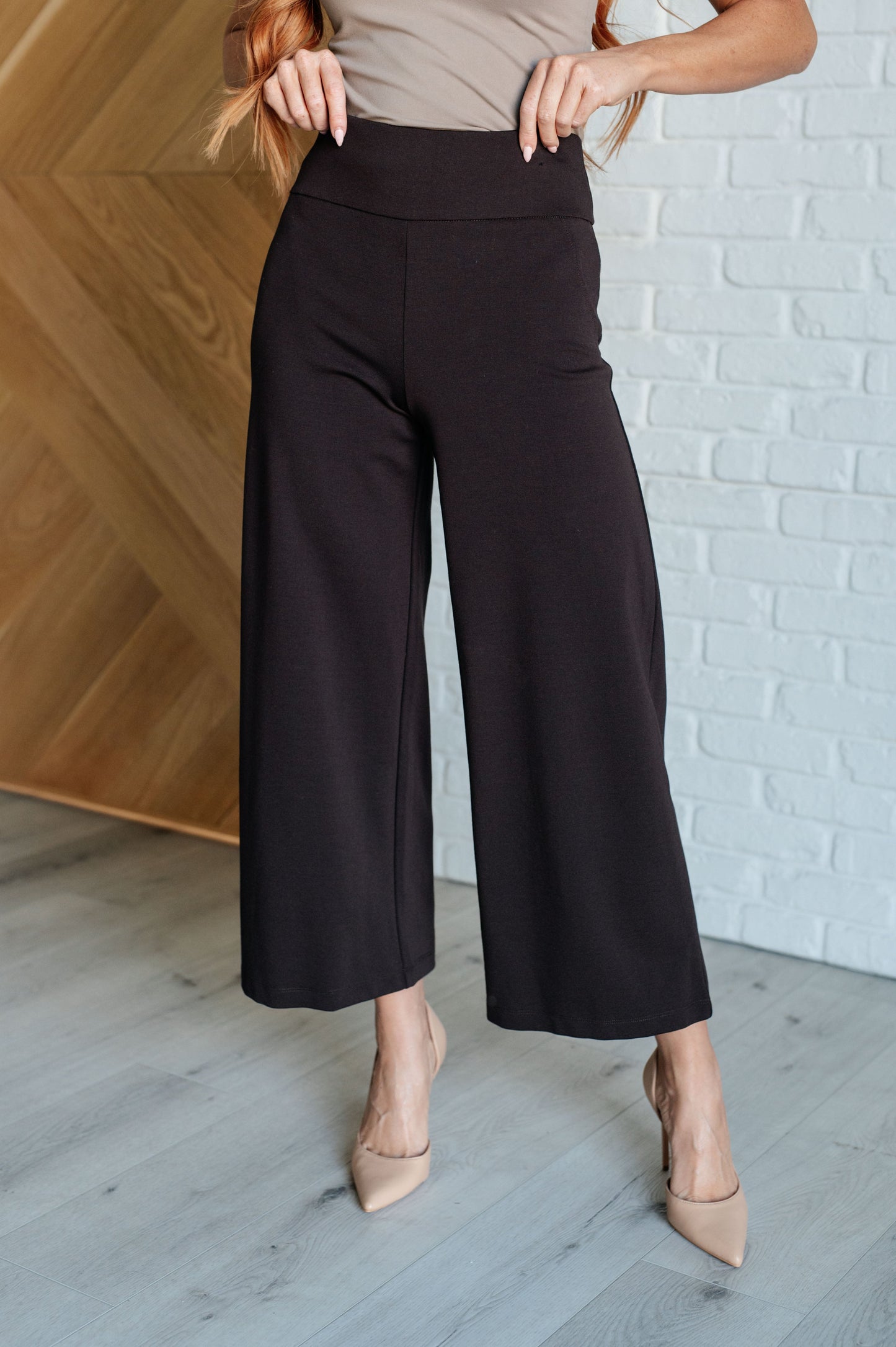 Wide Leg Crop Pants in chocolate, made from stretchy ponte knit fabric. Featuring a wide-leg design, cropped length, and faux welt pocket for a chic, comfortable look