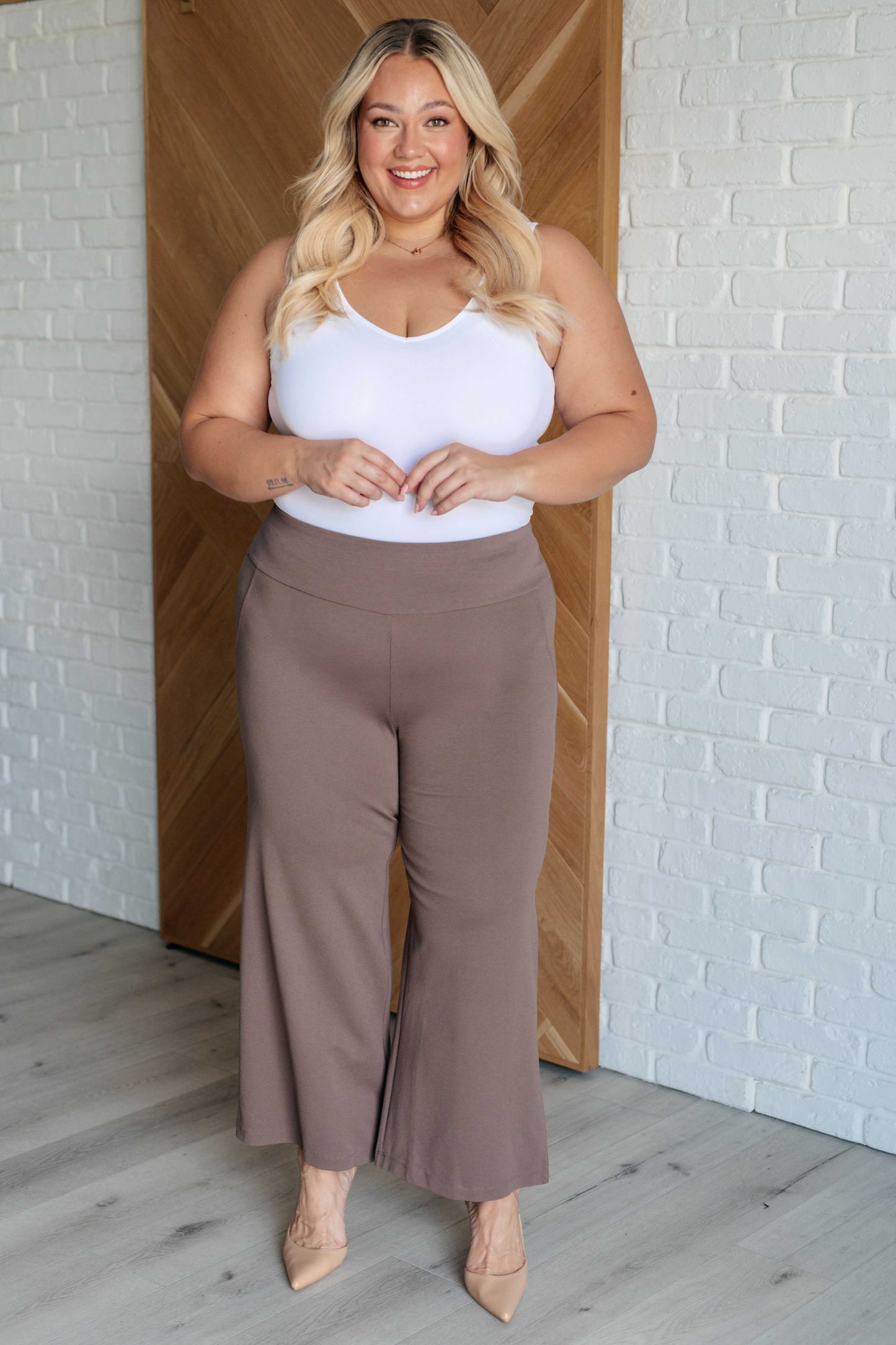 Wide Leg Crop Pants in dark mocha, made from high-stretch ponte knit fabric. Cropped, wide-leg design with faux welt pocket. Perfect for effortless style.