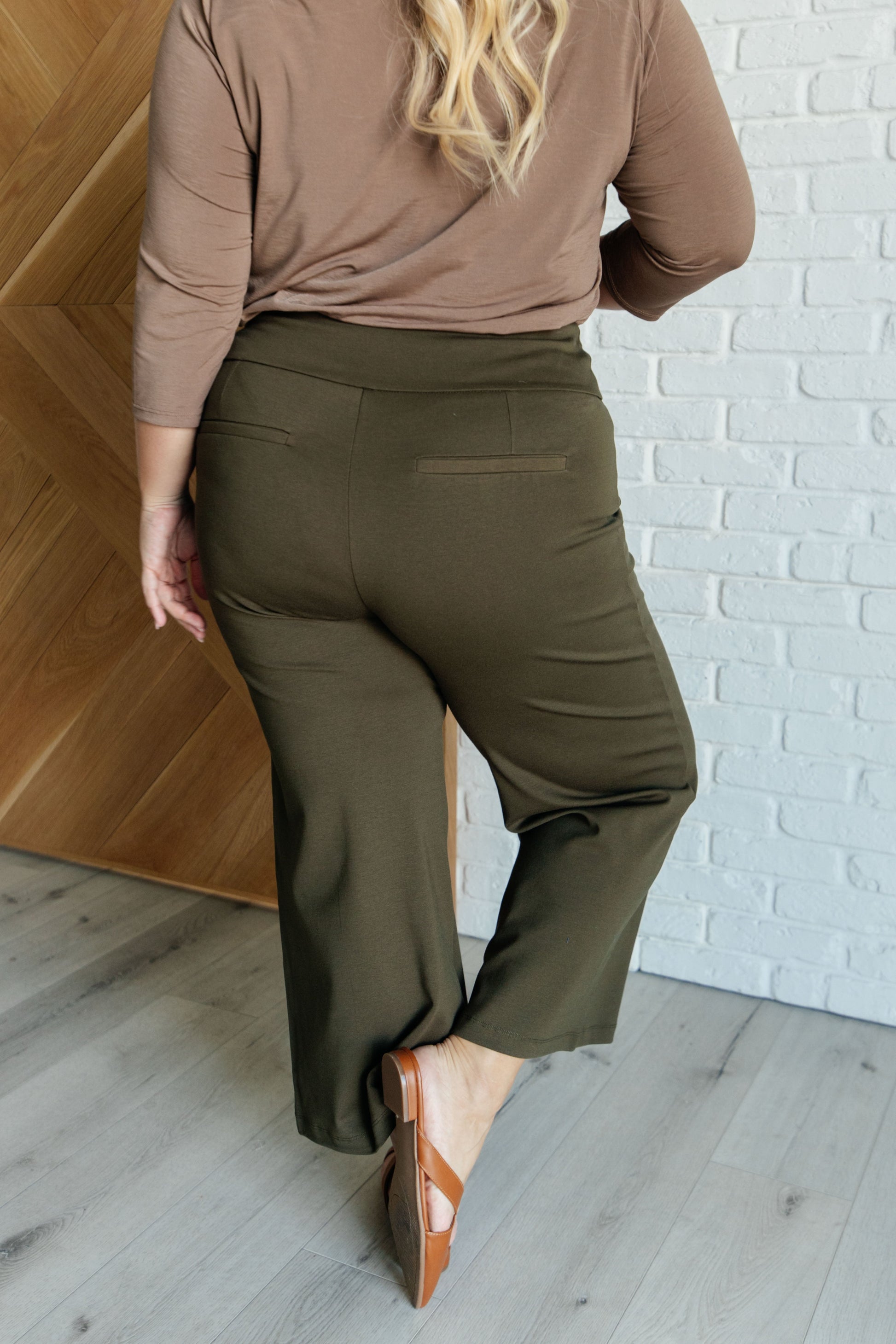 Wide Leg Crop Pants in olive, made from high-stretch ponte knit fabric. Cropped, wide-leg design with faux welt pocket. Perfect for effortless style.