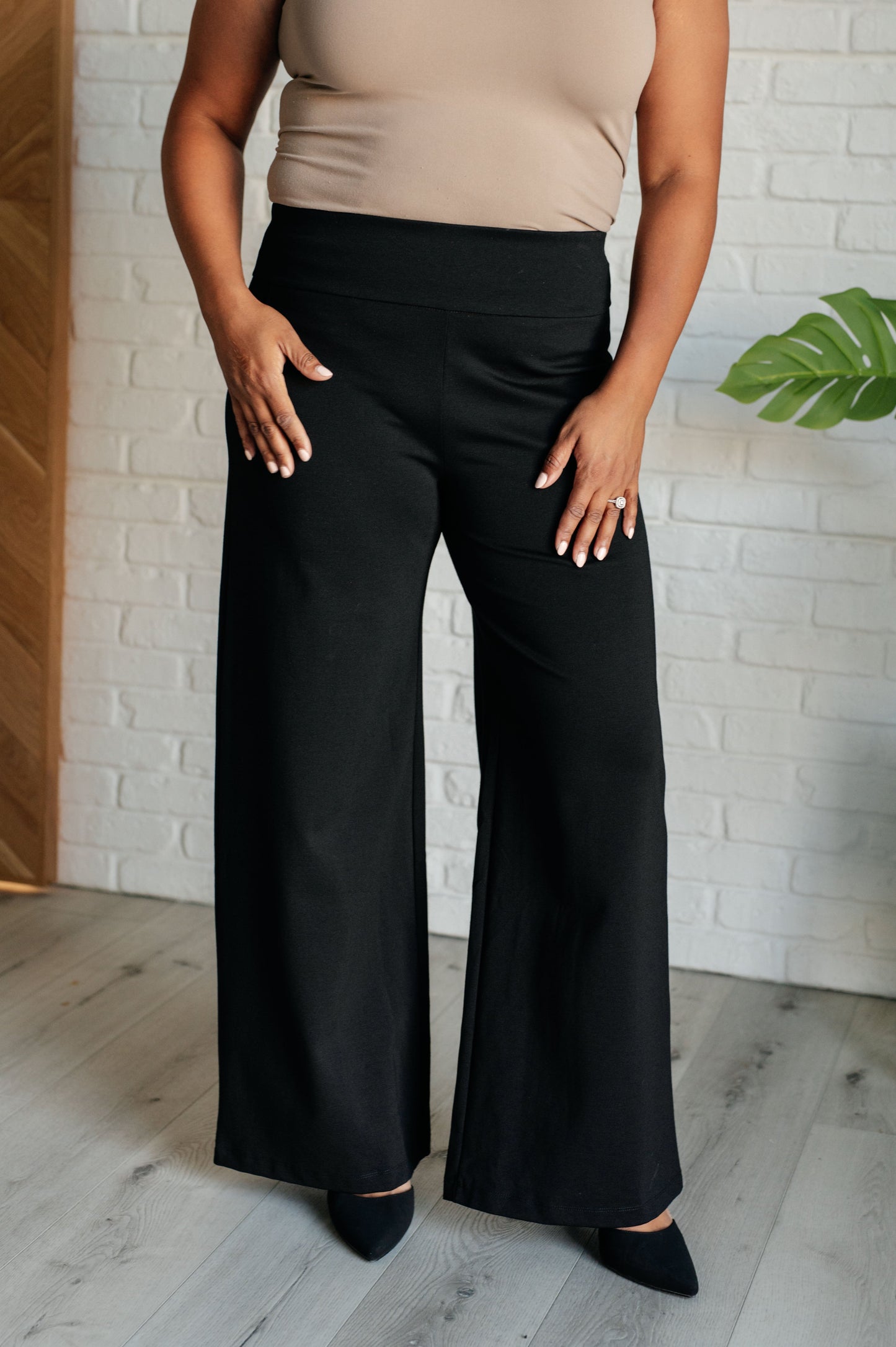 Wide Leg Pants in black, made from high-stretch ponte knit fabric, featuring faux welt pockets and a flattering wide leg silhouette.