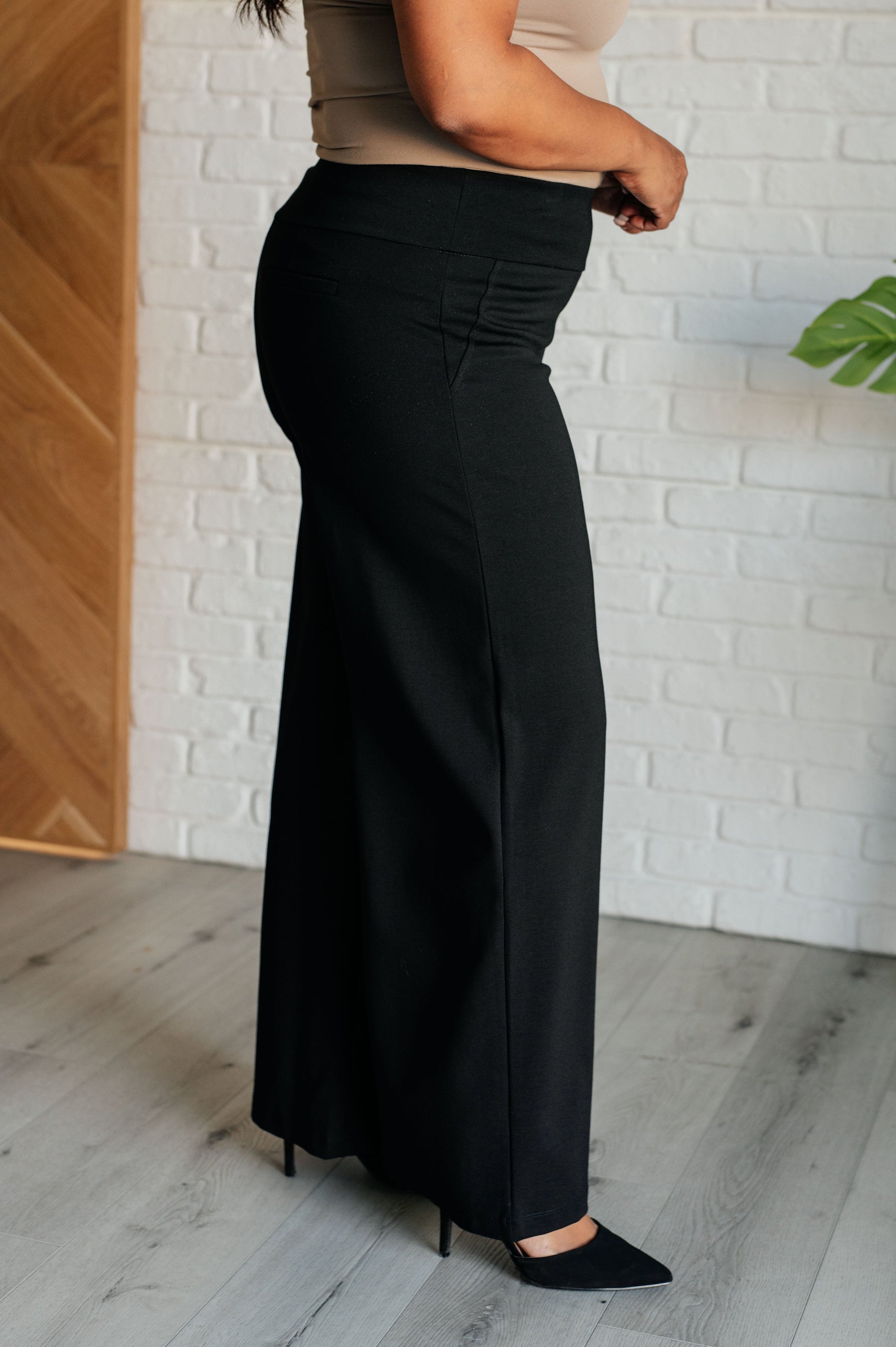 Wide Leg Pants in black, made from high-stretch ponte knit fabric, featuring faux welt pockets and a flattering wide leg silhouette.