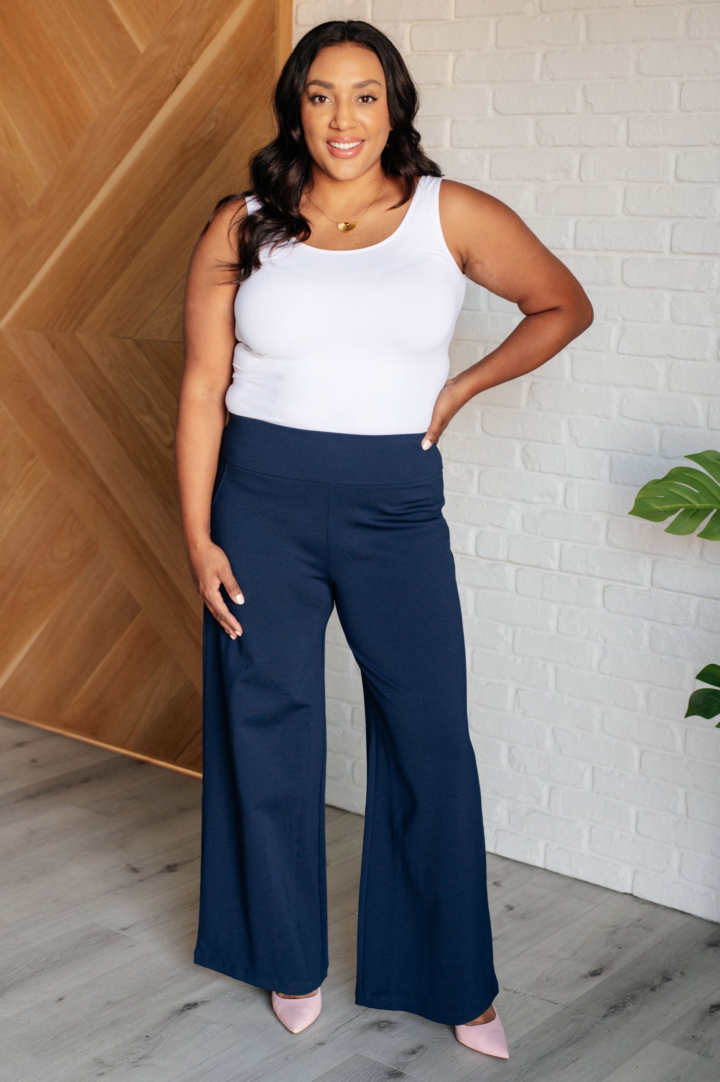 Wide Leg Pants in navy, made from high-stretch ponte knit fabric, featuring faux welt pockets and a flattering wide leg silhouette.