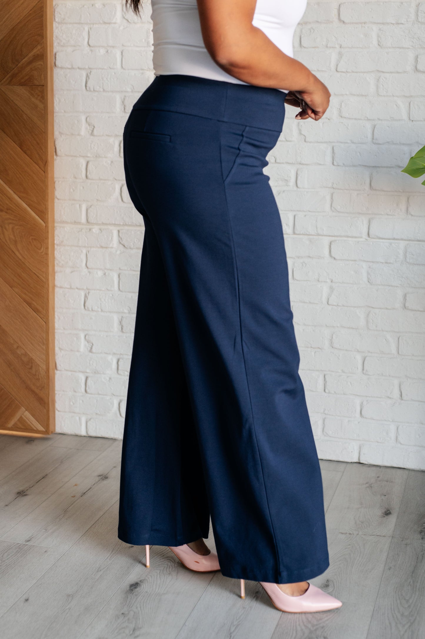 Wide Leg Pants in navy, made from high-stretch ponte knit fabric, featuring faux welt pockets and a flattering wide leg silhouette.