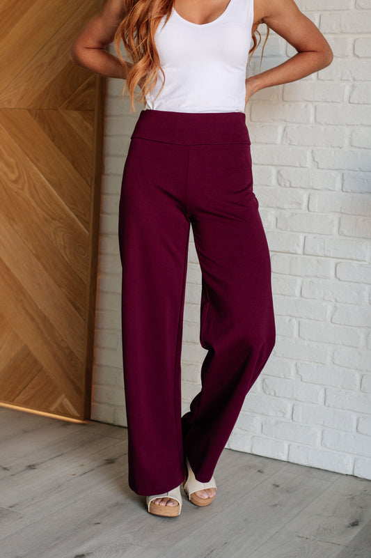 Wide Leg Pants in wine, made from high-stretch ponte knit fabric, featuring faux welt pockets and a flattering wide leg silhouette.