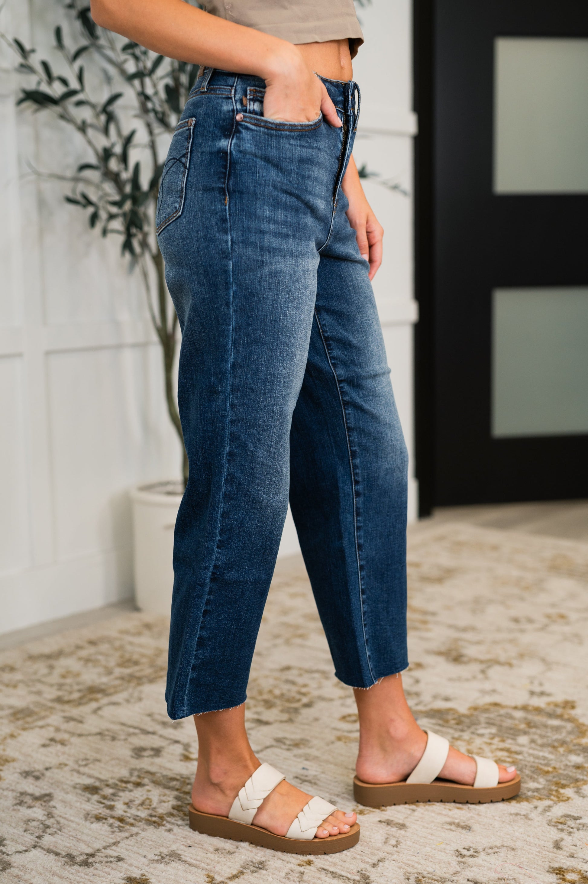 Side view of Maisie crop wide leg jeans highlighting the flattering high-rise fit and raw hem.