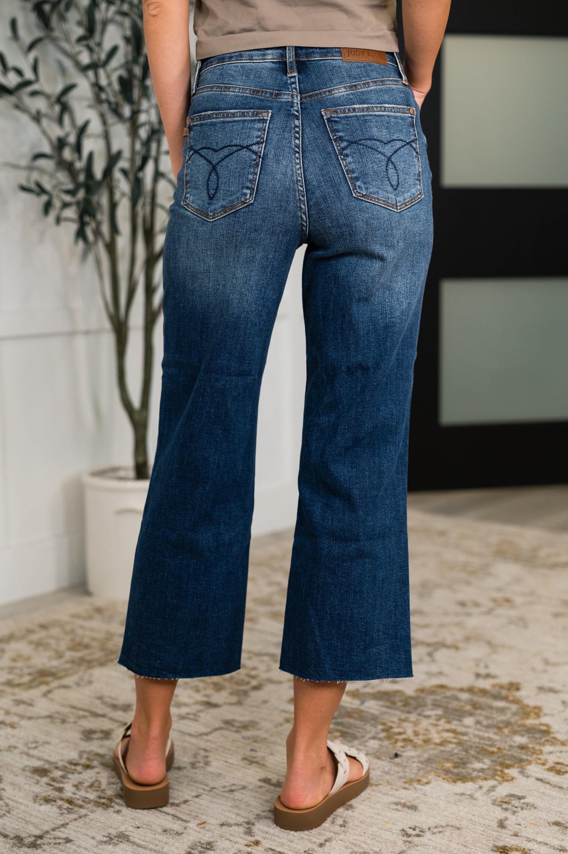Back view of Maisie crop wide leg jeans showcasing embroidered back pockets and wide leg silhouette.