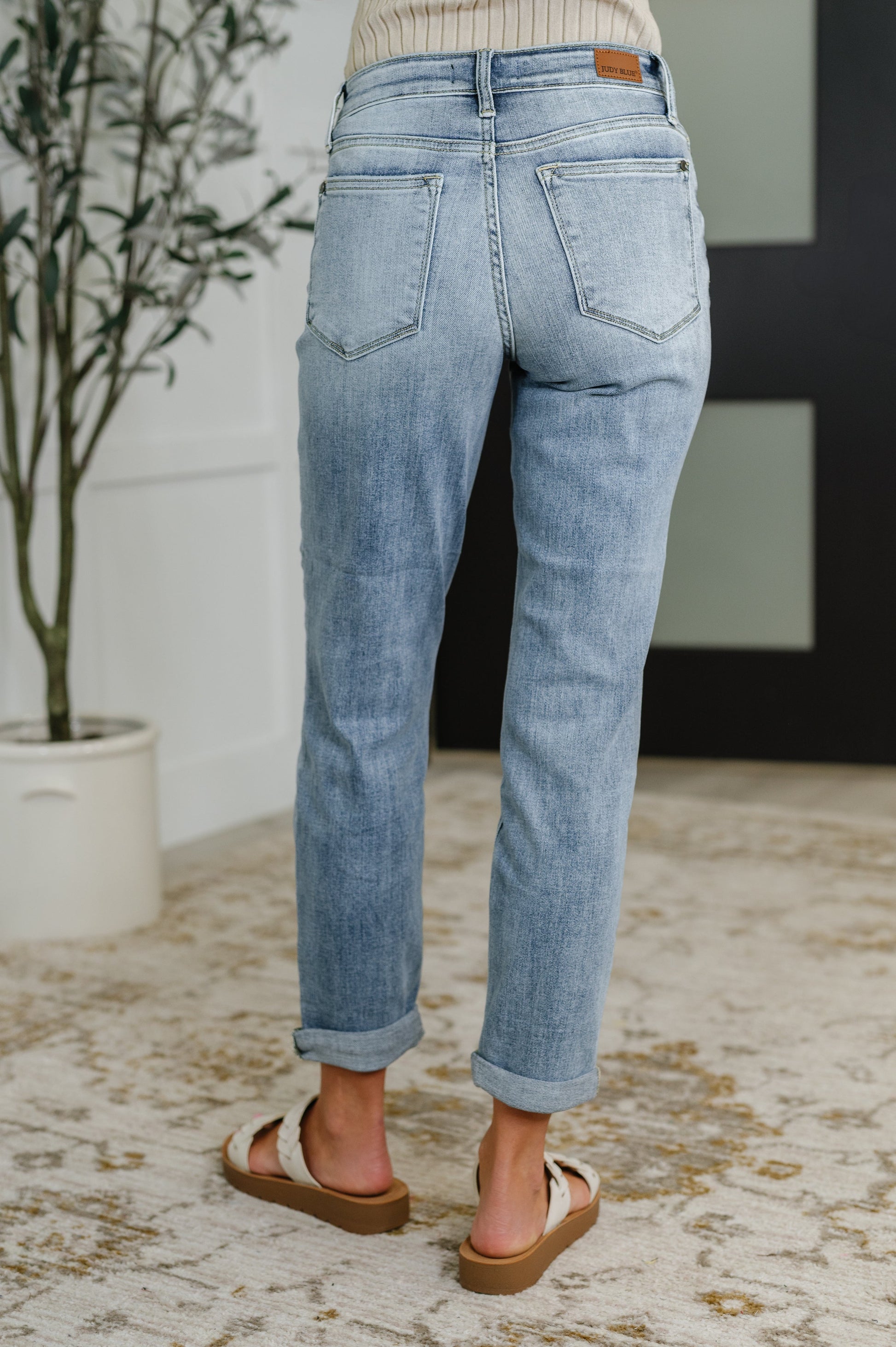 Back view of stretchy bleach wash Judy Blue boyfriend jeans – relaxed fit mid-rise style for all sizes.