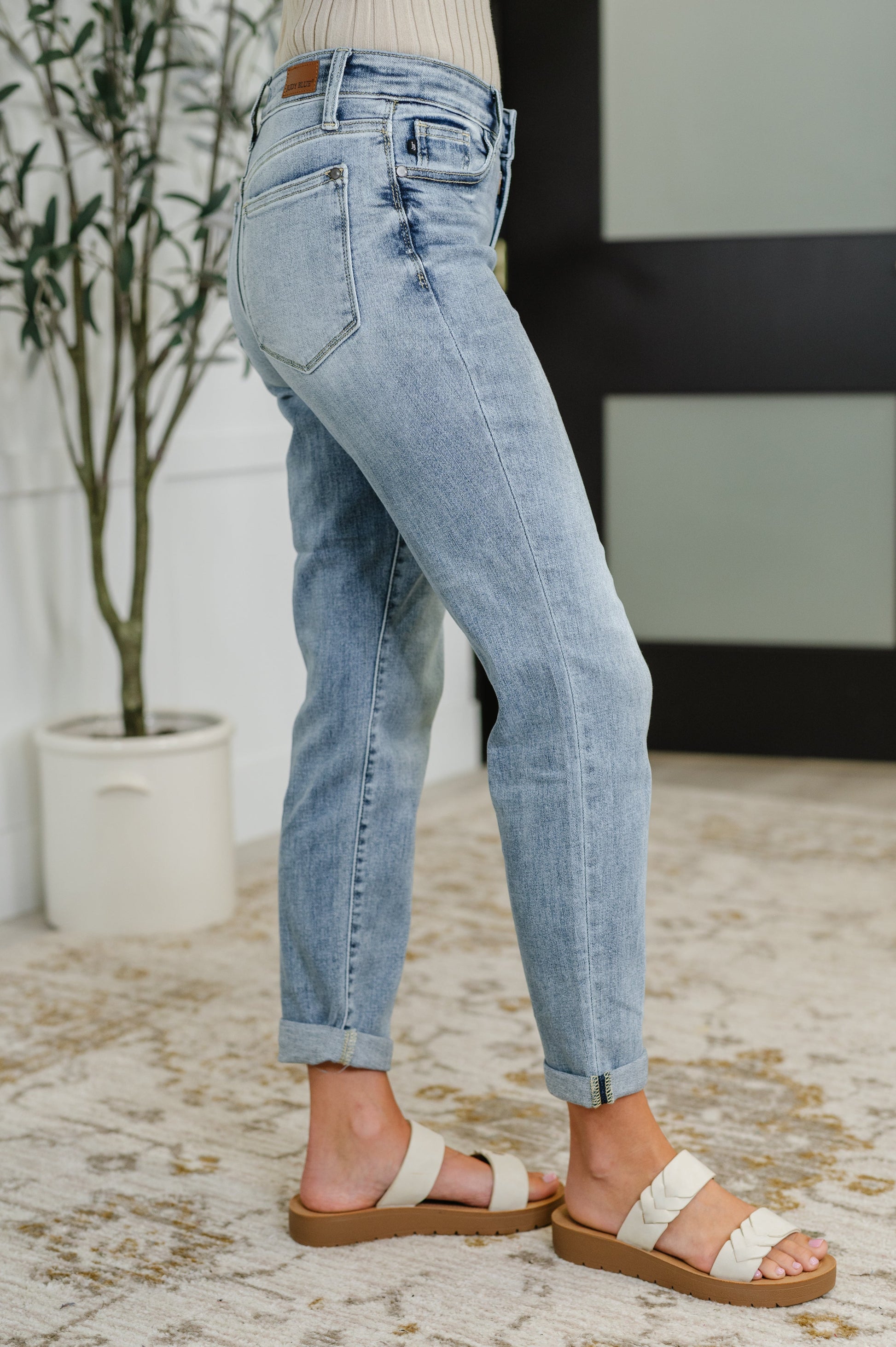 Side view of Mallory mid-rise boyfriend jeans – light wash, size inclusive, with cuffed hems and 4-way stretch.
