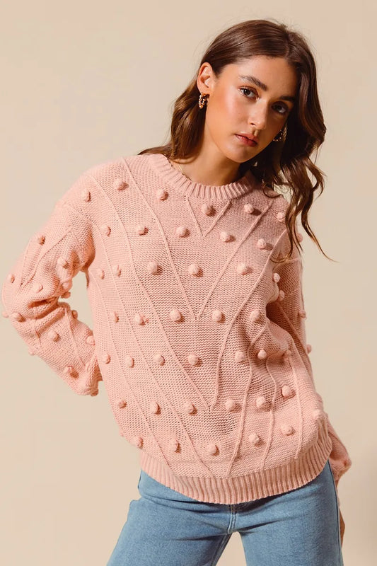 Front view of blush Marcella Pom Pom Textured Knit Sweater with round neck and playful pom pom details