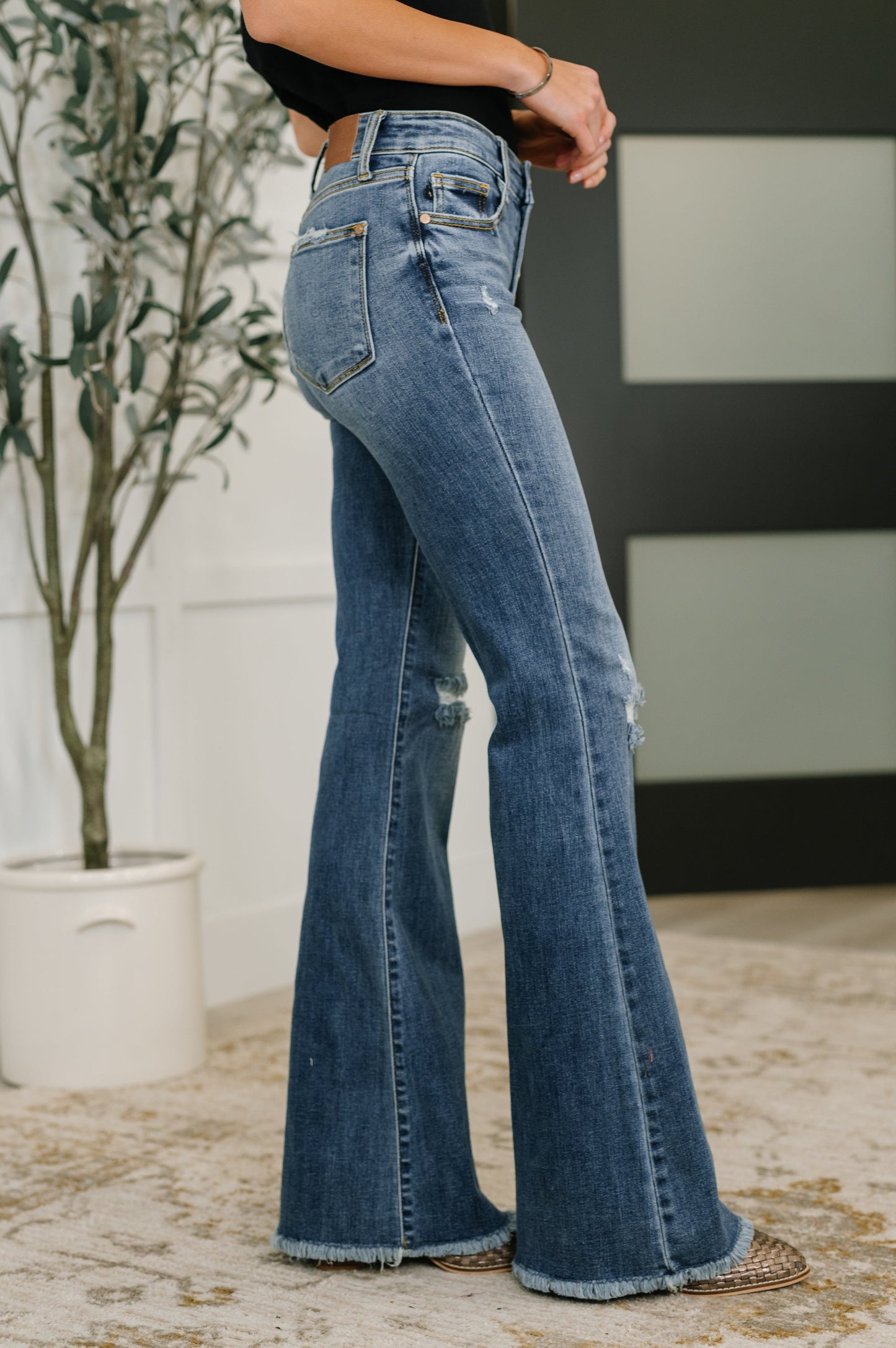Side view of Marion Mid Rise Flare Jeans showing flare silhouette and medium wash.