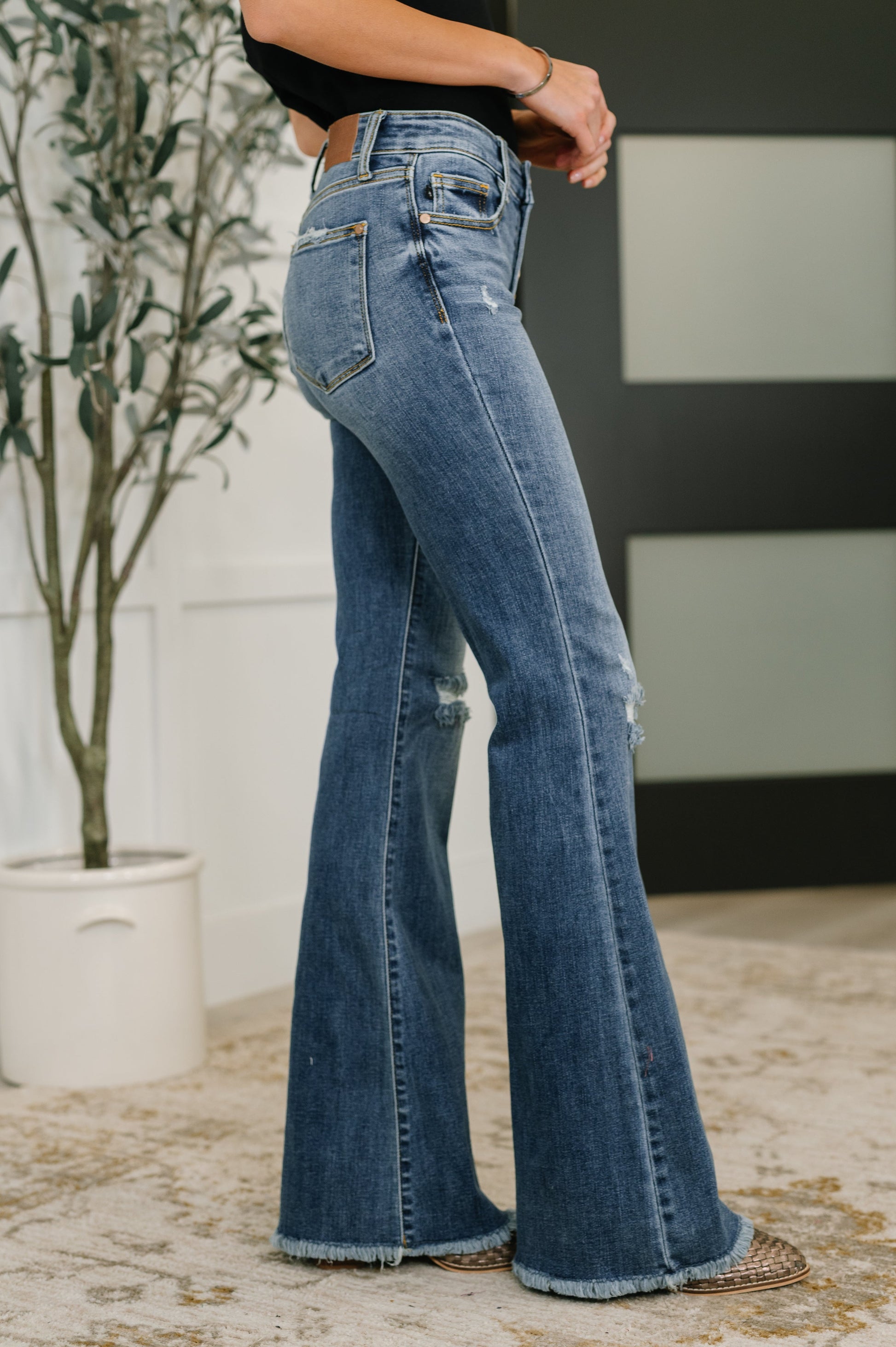 Side view of Marion Mid Rise Flare Jeans showing flare silhouette and medium wash.