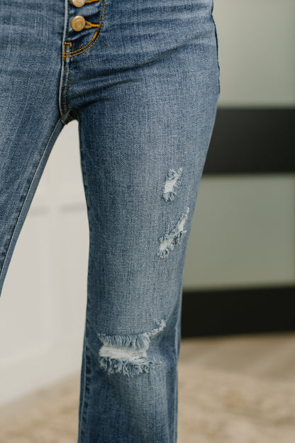 Detail shot of Marion Mid Rise Flare Jeans distressing on leg and soft stretch fabric.