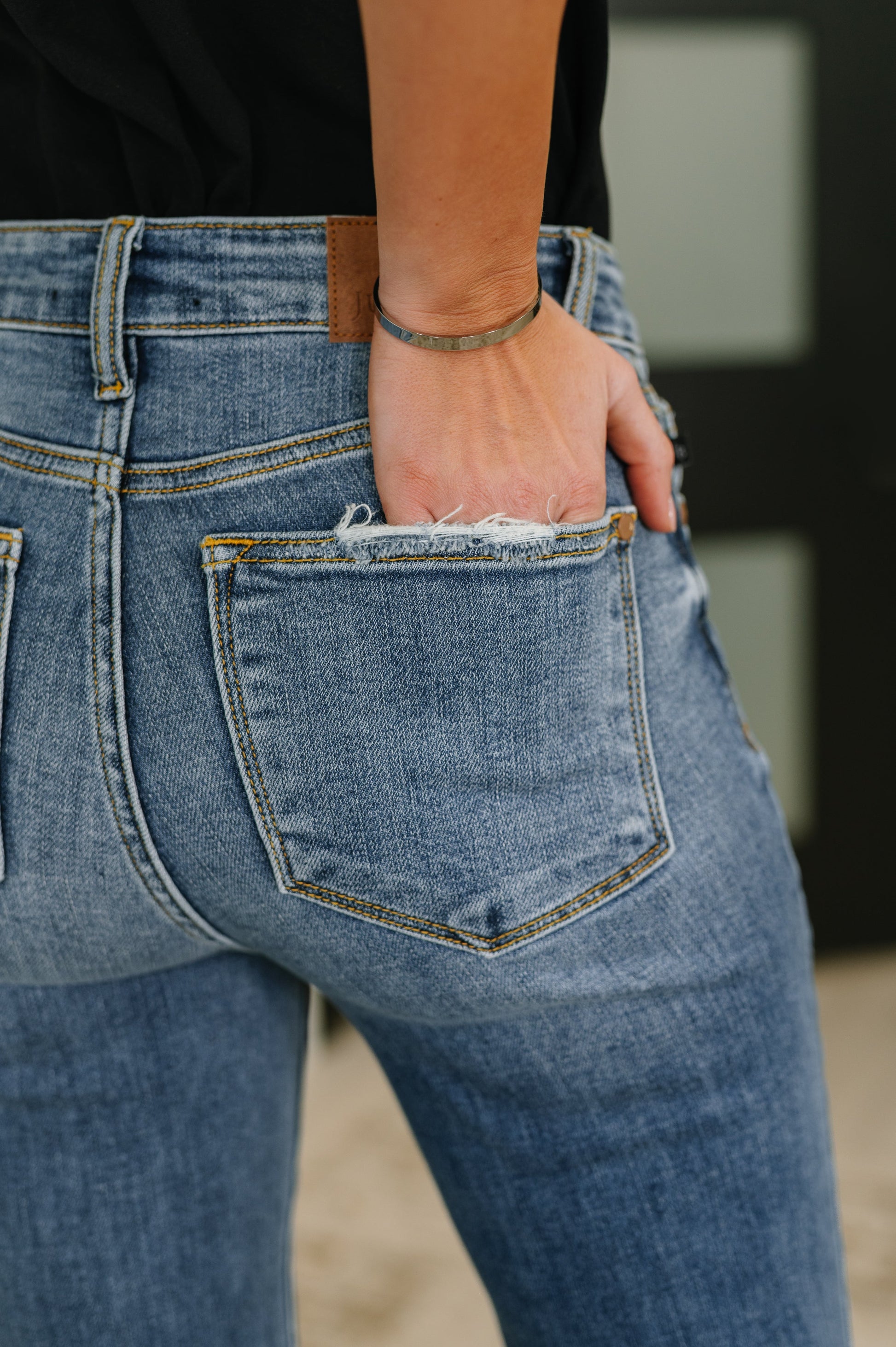 Close-up of Marion Mid Rise Flare Jeans pocket detail.