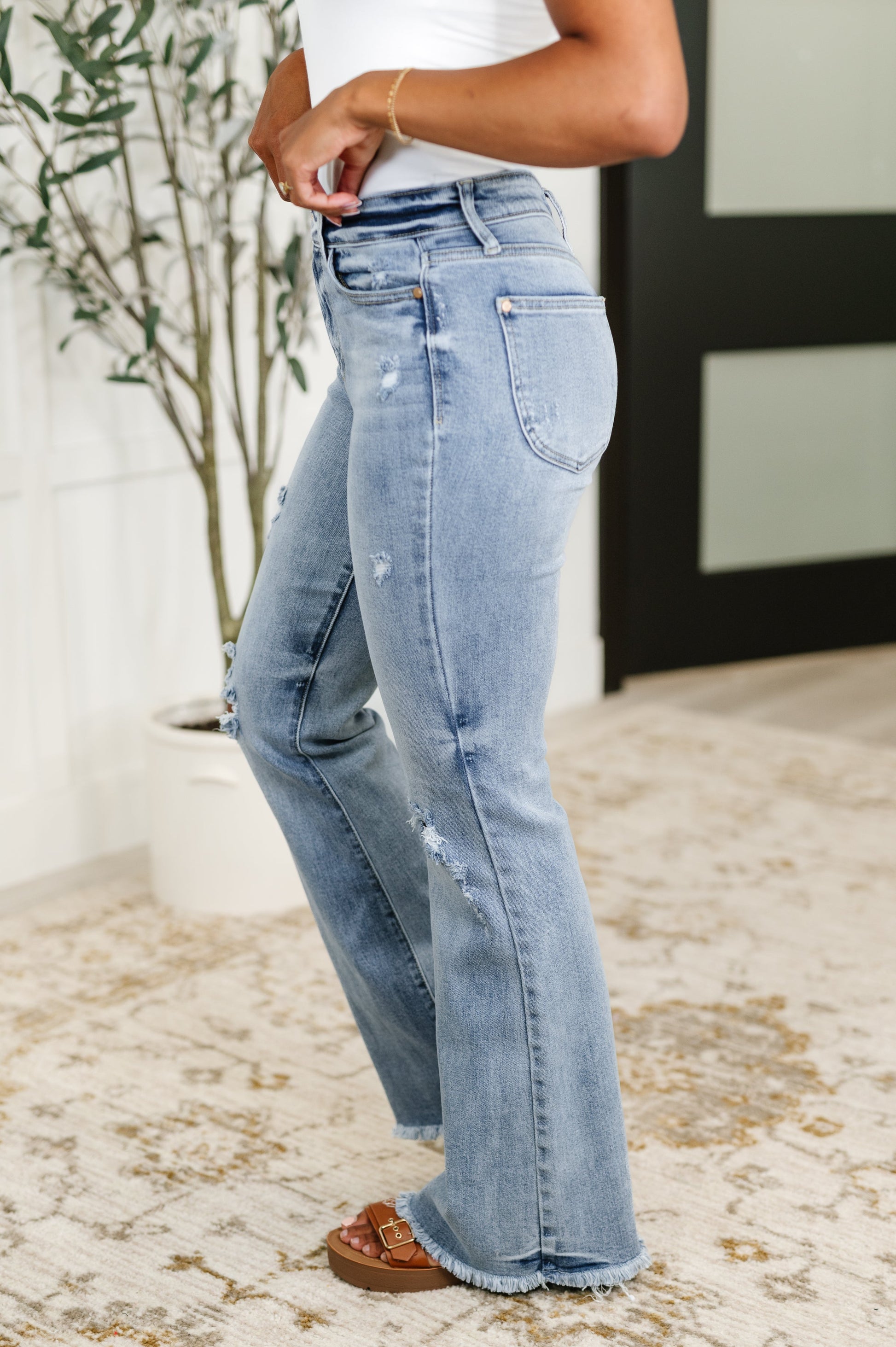 Side view of Marlena High Rise Flare Jeans showing flared silhouette, light wash denim, and curve-flattering fit.