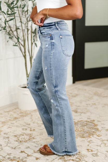 Side view of Marlena High Rise Flare Jeans showing flared silhouette, light wash denim, and curve-flattering fit.