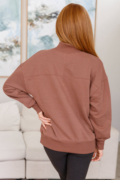 Back view of cocoa sweatshirt fleece pullover with mock neckline and long sleeves.