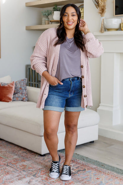 Plus size model pairing Martha Buttoned Down Cardigan with casual layers.