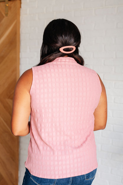 Plus-size model back view of Eva pleat front blouse in pink with smooth, lightweight silhouette.