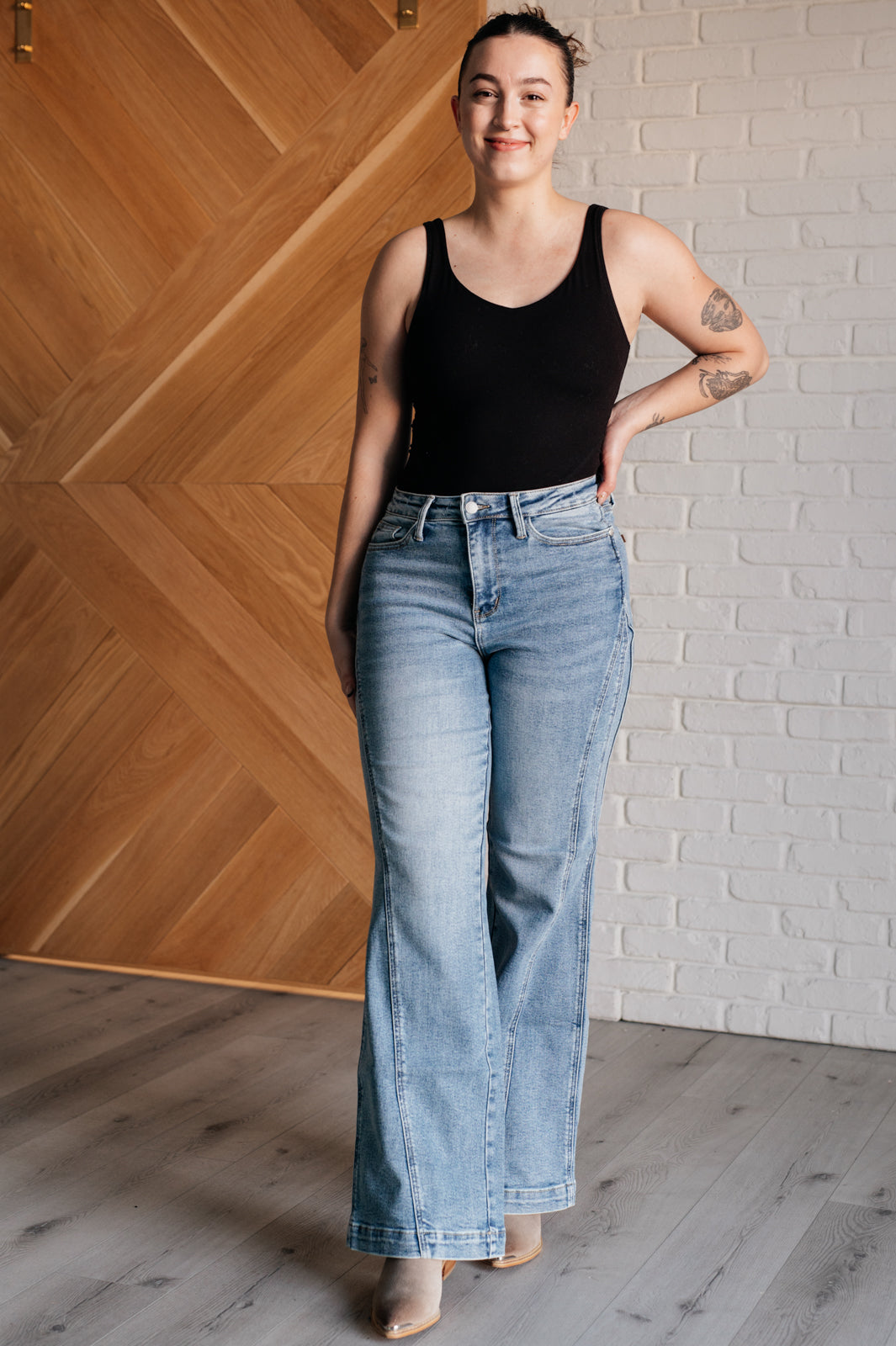 Melia High Rise Side Seam Detail Wide Leg Jeans by Judy Blue in a light wash, featuring a retro-inspired wide-leg silhouette, high-rise fit, asymmetrical side seam detail, zip fly closure, and 4-way stretch for comfort and style.