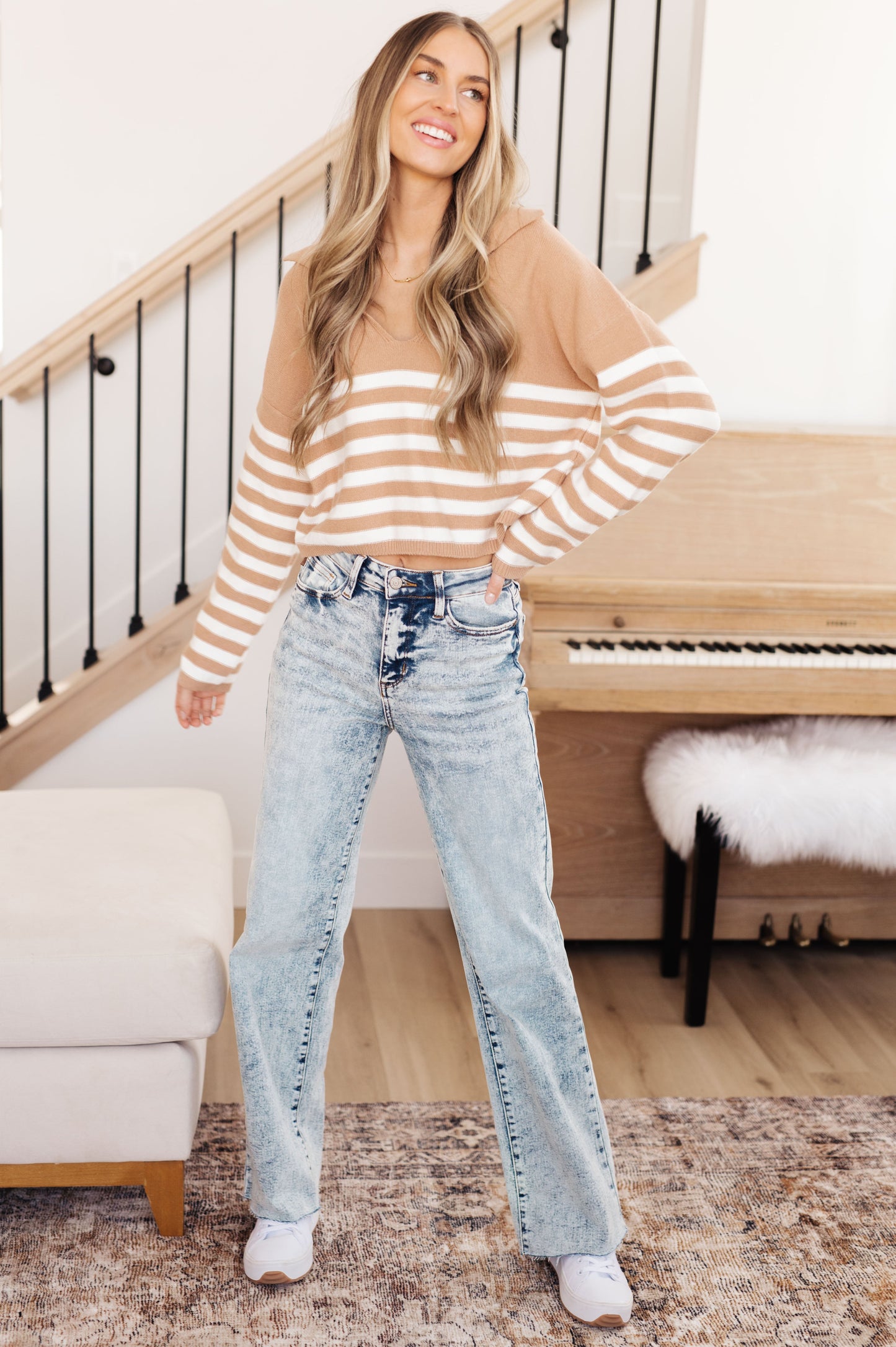 A striped midweight sweater knit in white and beige featuring a collared V-neckline, long sleeves, and a cropped length with a relaxed fit.