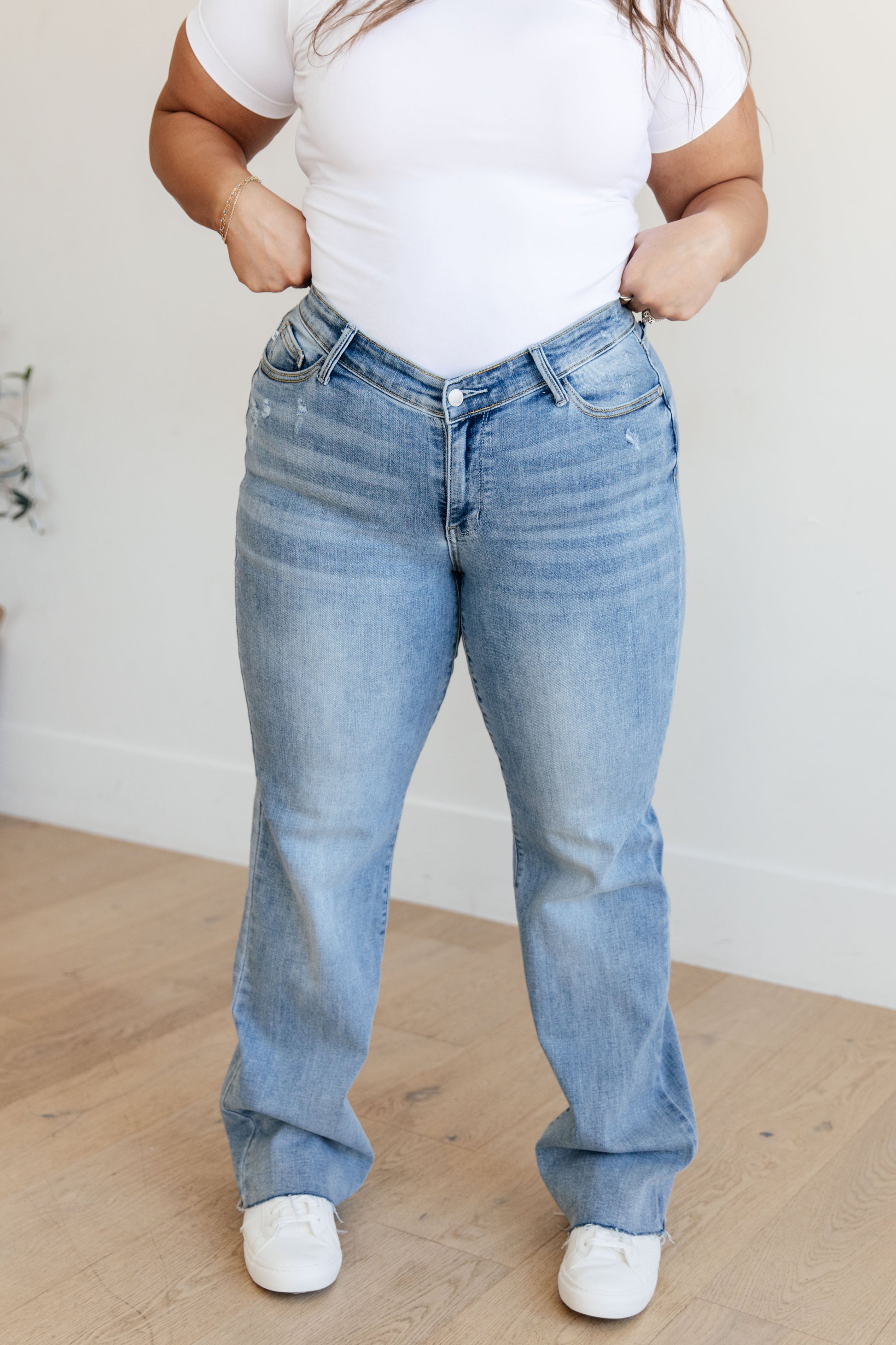 Light wash high-rise straight leg jeans with a V-front waistband, raw hem, and 4-way stretch for a flattering fit and comfort.