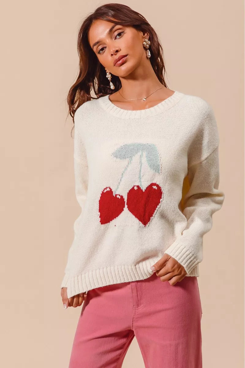 Model wearing Gina Heart Cherry Knitted Valentine Sweater Top in ivory.