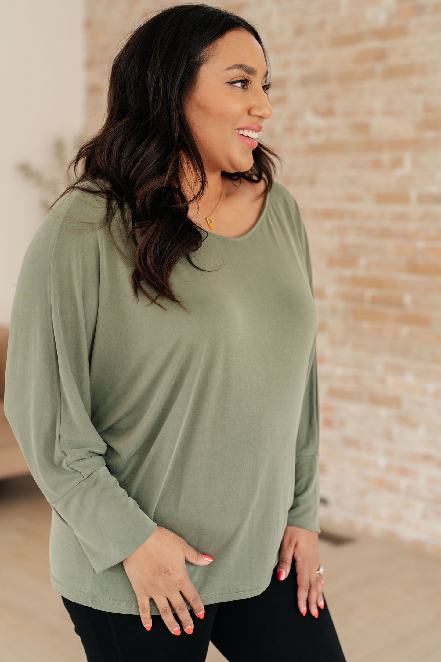 Side view of Micah Sage Long Sleeve Top focusing on boat neckline and exaggerated sleeve cuffs