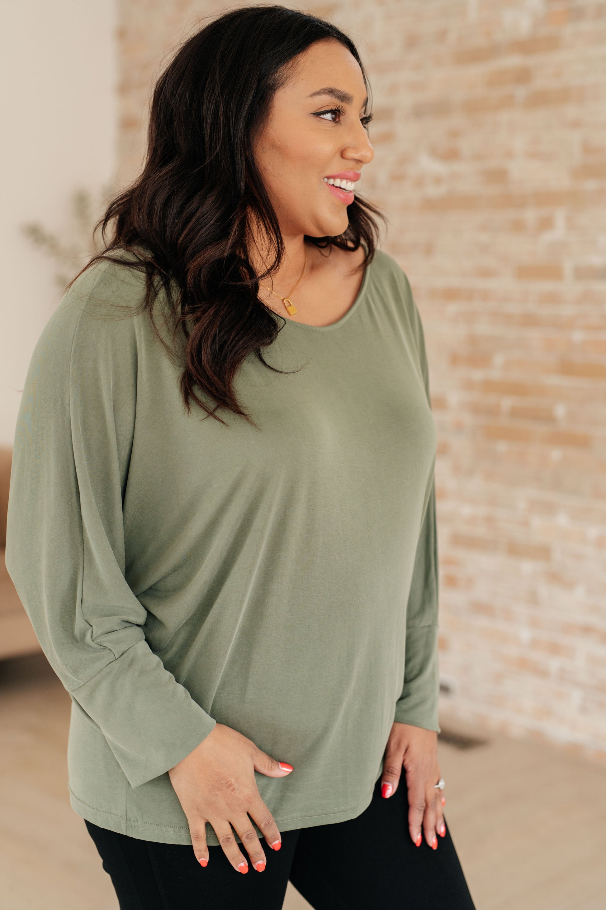 Side view of Micah Sage Long Sleeve Top focusing on boat neckline and exaggerated sleeve cuffs