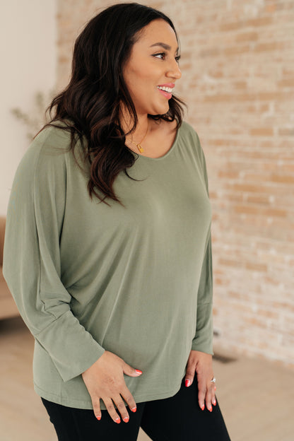 Side view of Micah Sage Long Sleeve Top focusing on boat neckline and exaggerated sleeve cuffs