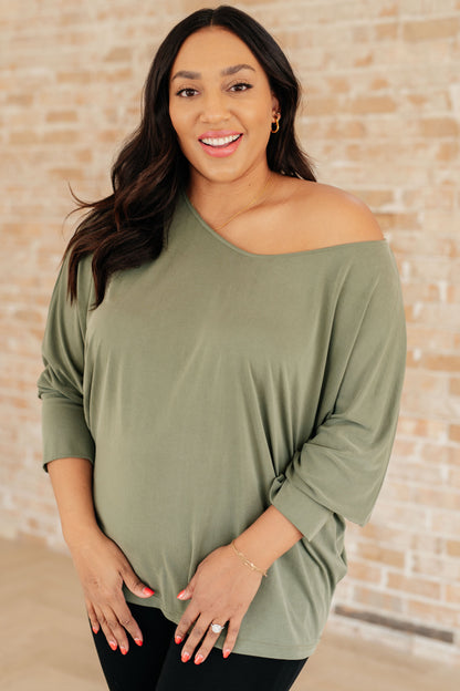 Plus size model front view wearing Micah Sage Long Sleeve Top with boat neckline and dolman sleeves