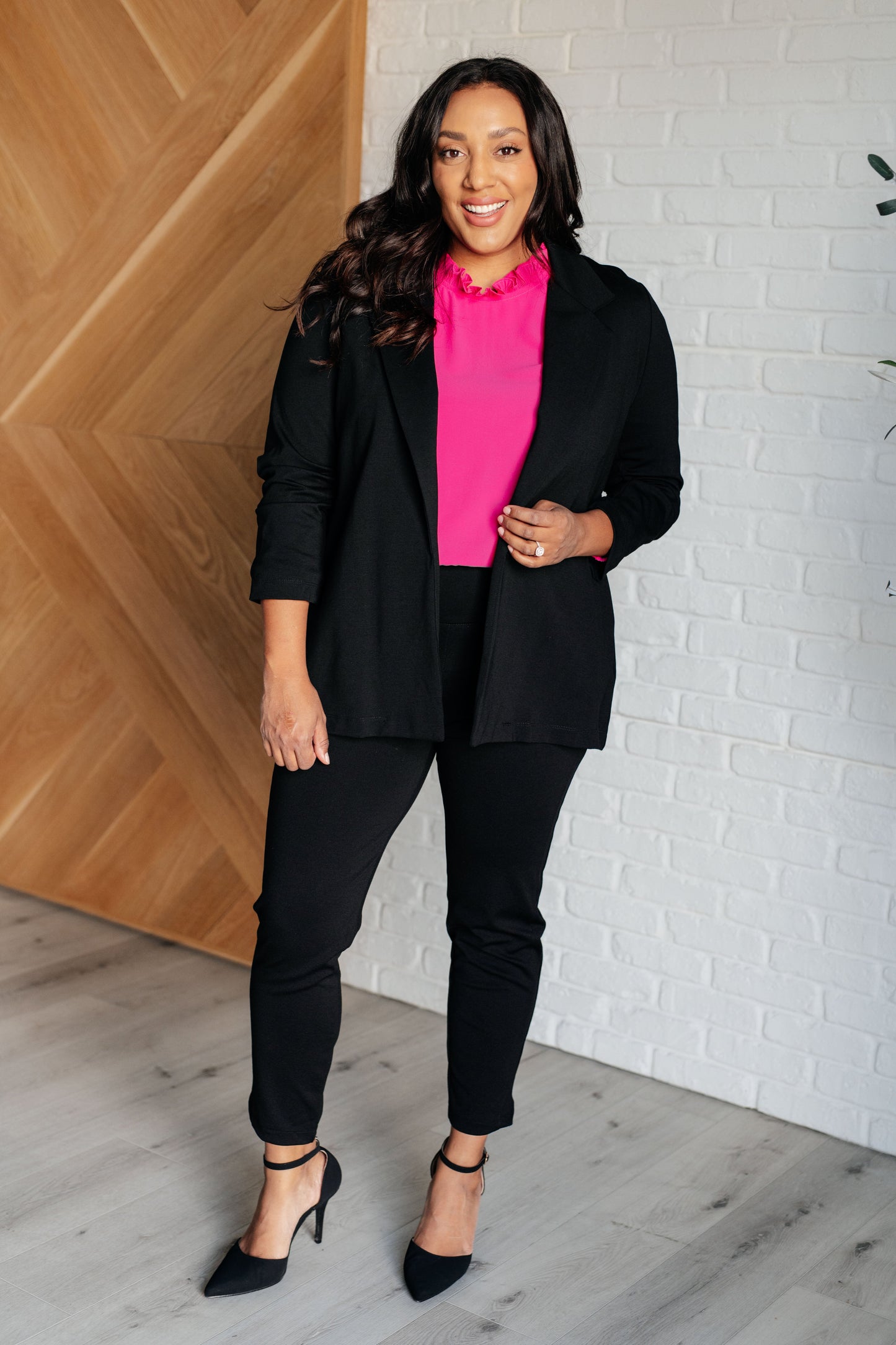 Soft Poly Crepe top in hot pink with mock neckline, ruffle details, long balloon sleeves with elastic cuffs, and keyhole button closure. Lined bodice.