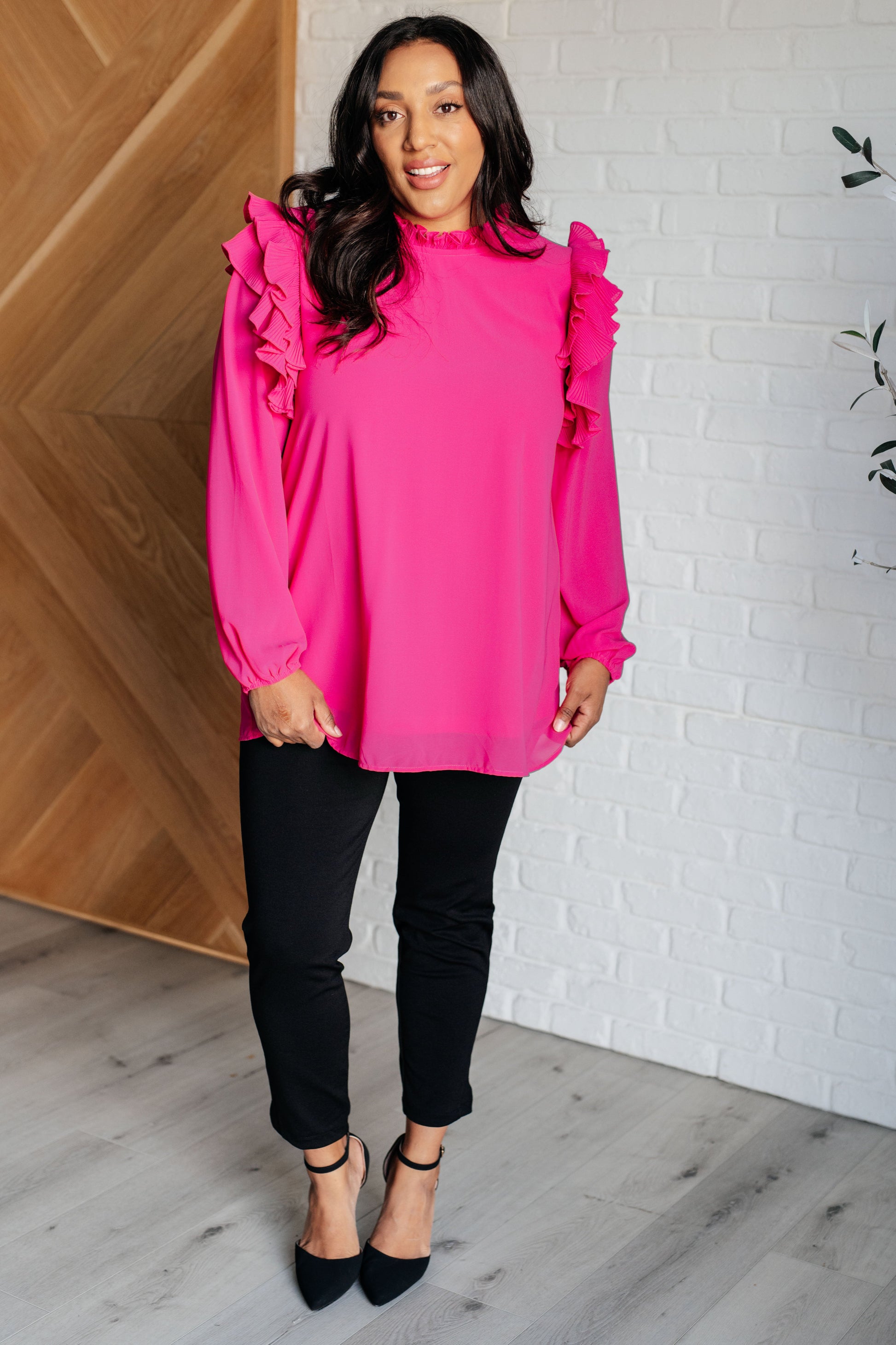 Soft Poly Crepe top in hot pink with mock neckline, ruffle details, long balloon sleeves with elastic cuffs, and keyhole button closure. Lined bodice.