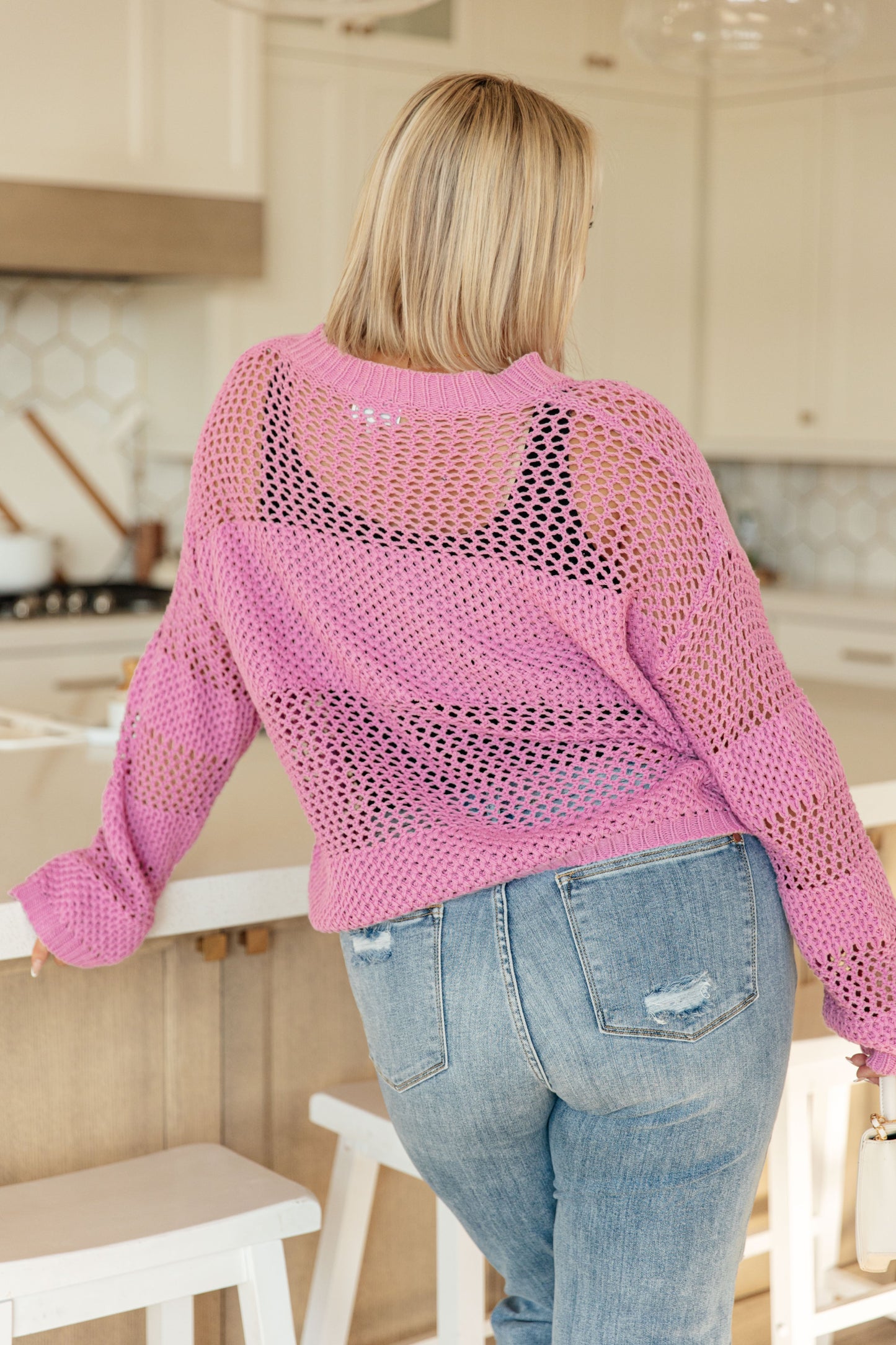 Back view of the Leia Pink Open Knit Sweater showing the sheer loose-knit design and wide block stripe pattern.