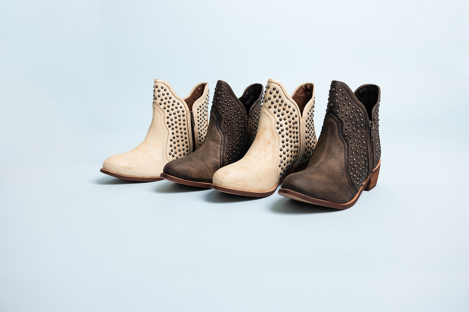 Nailed it ankle boots with nail head stud accents, sleek leather finish, and an outside zipper for easy wear. Stylish and versatile footwear for casual or dressy occasions.