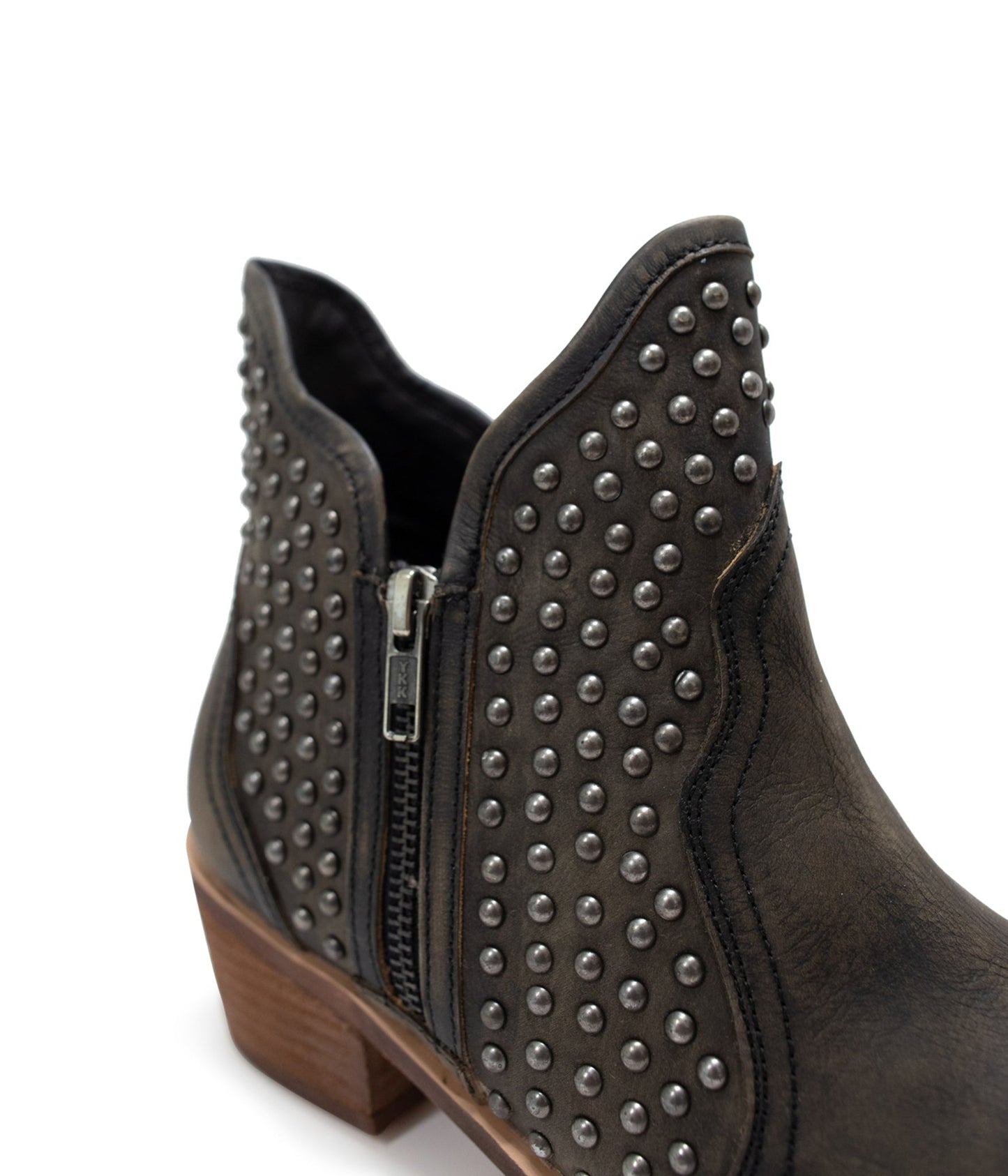 Black ankle boots with nail head stud accents, sleek leather finish, and an outside zipper for easy wear. Stylish and versatile footwear for casual or dressy occasions.