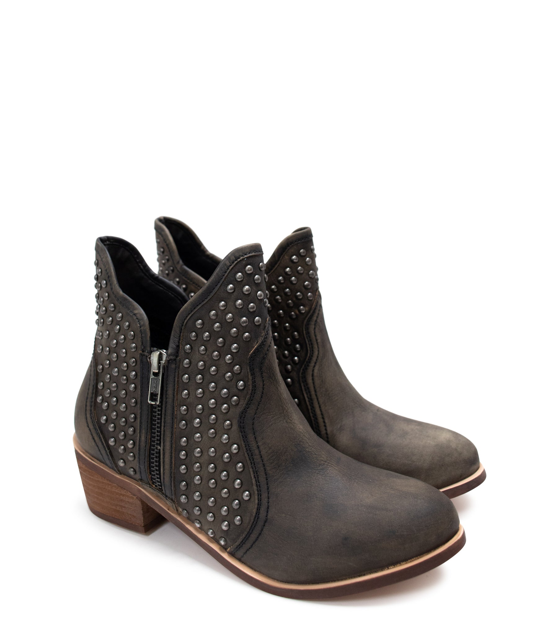 Black ankle boots with nail head stud accents, sleek leather finish, and an outside zipper for easy wear. Stylish and versatile footwear for casual or dressy occasions.