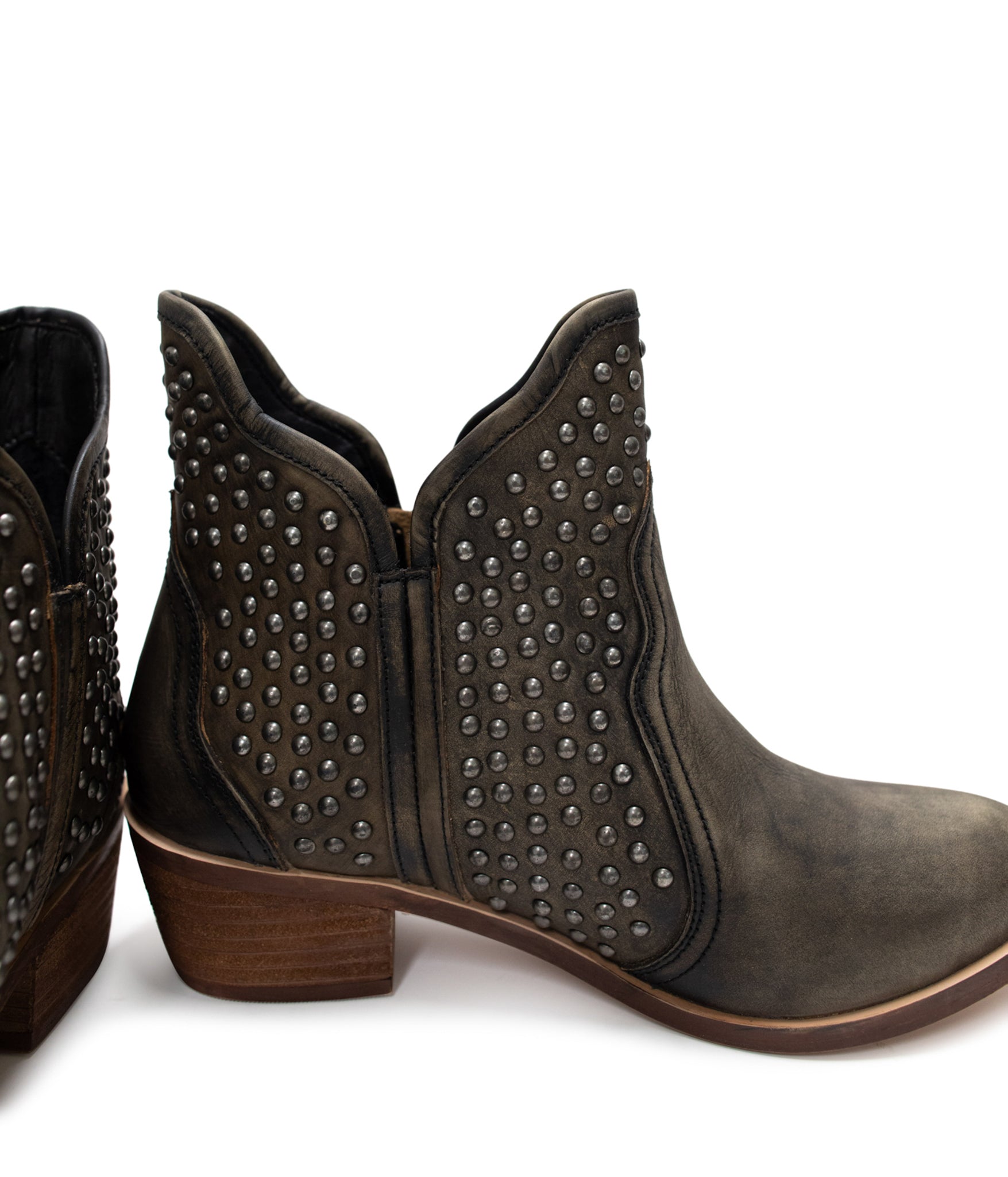 Black ankle boots with nail head stud accents, sleek leather finish, and an outside zipper for easy wear. Stylish and versatile footwear for casual or dressy occasions.