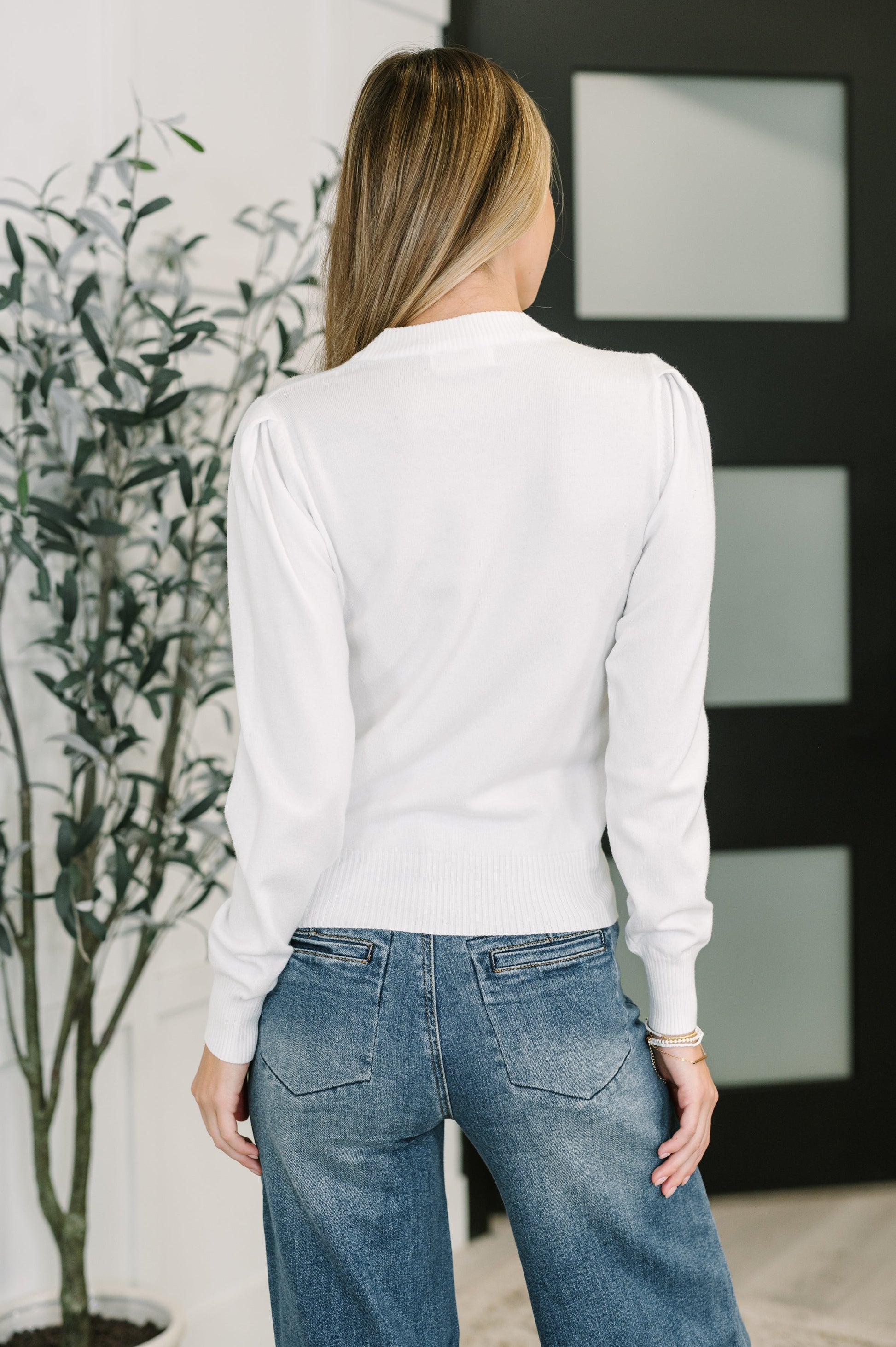 Back view of Nessy Long Sleeve Top in White with fitted ribbed cuffs and relaxed silhouette.