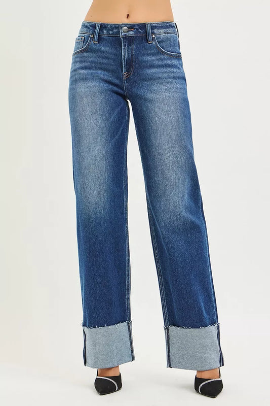 Model wearing Nina Wide Straight Jeans by Risen dark wash with raw cuffed hem.