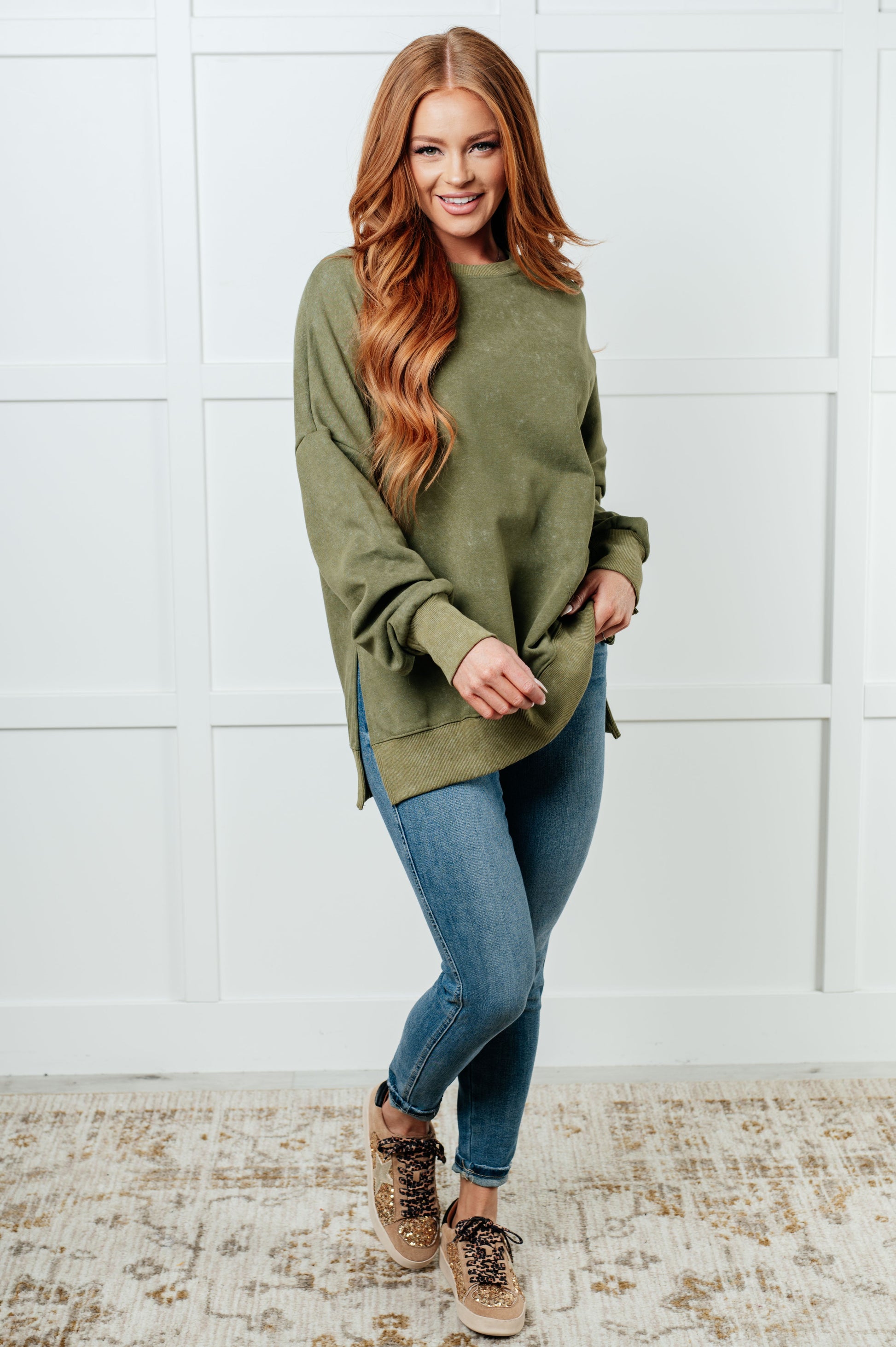 A women's French terry sweatshirt in mineral wash green with a crew neckline, long sleeves, side slits, and ribbed cuffs and hem. 