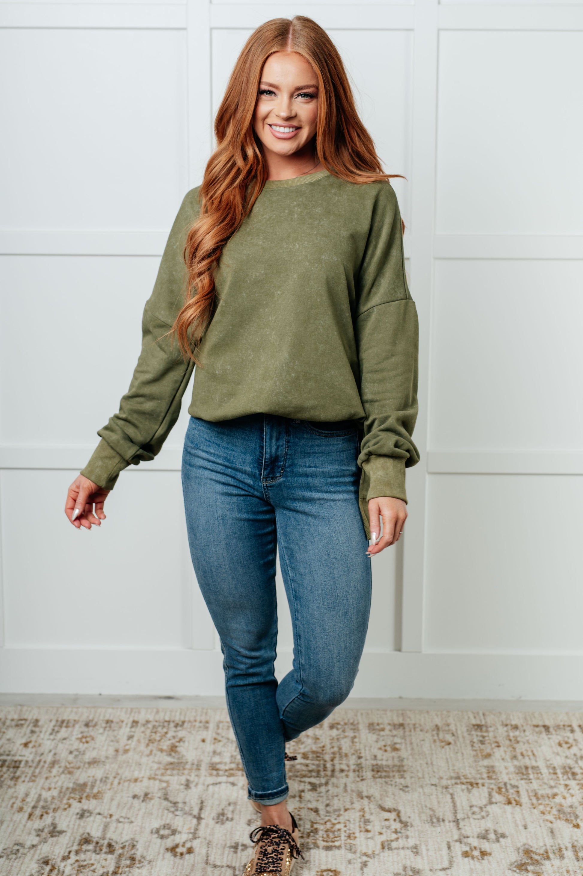 A women's French terry sweatshirt in mineral wash green with a crew neckline, long sleeves, side slits, and ribbed cuffs and hem. 